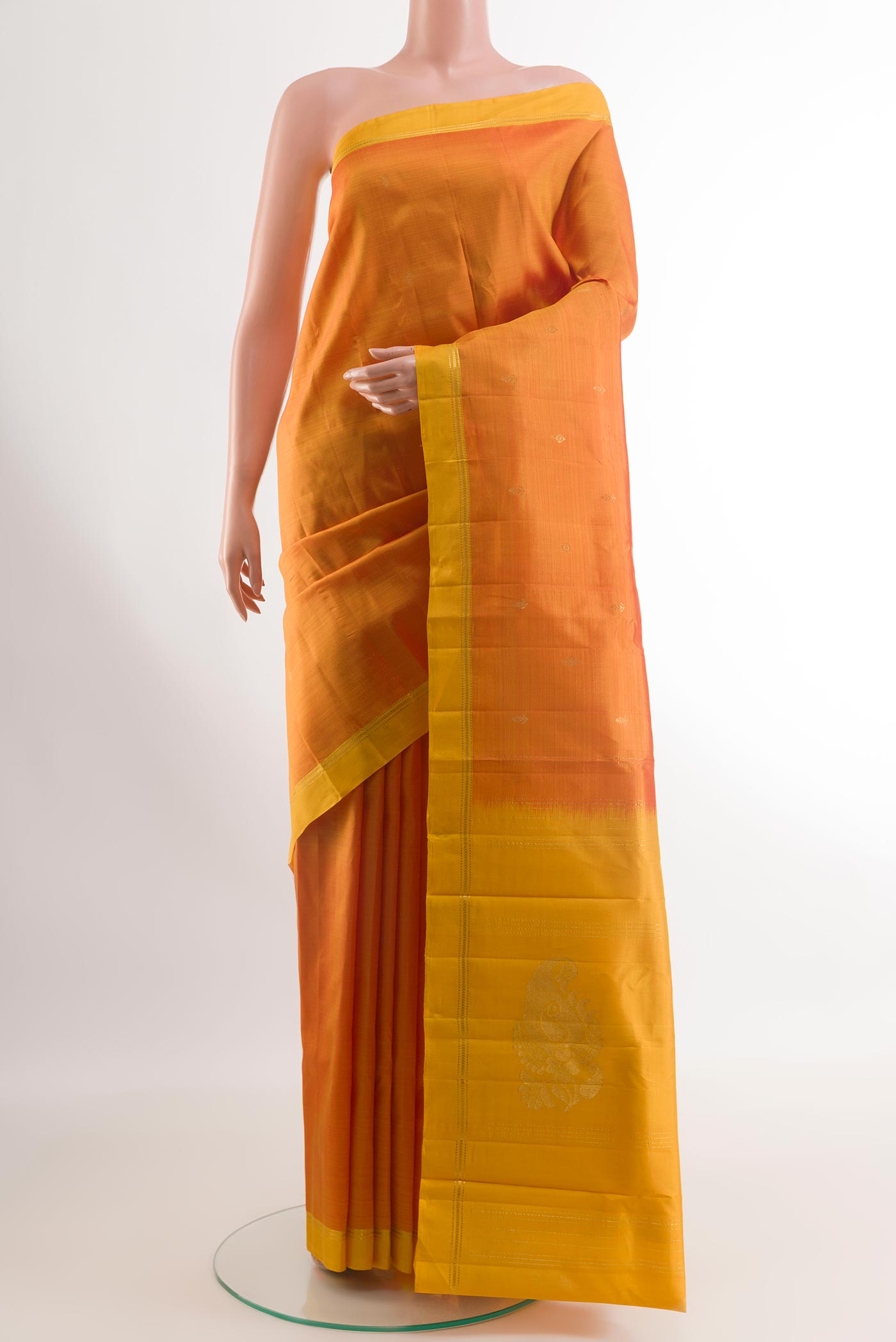 Orange Kanchipuram Silk Saree with Zari Butta on the body and Zari Border.  displayed on a mannequin