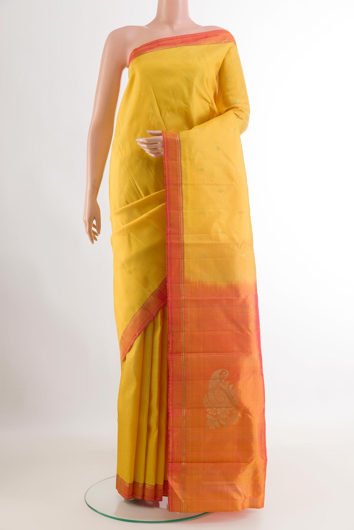 Yellow Kanchipuram Silk Saree with Zari Butta on the body and Zari Border.  displayed on a mannequin