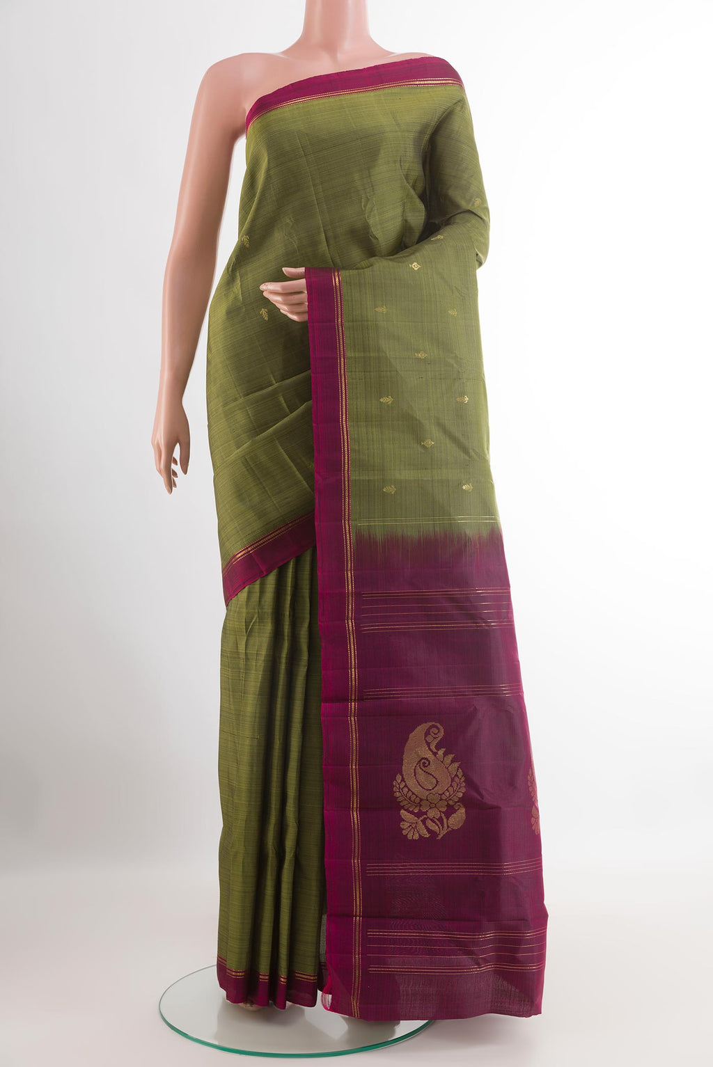 Mehandi Green Kanchipuram Silk Saree with Zari Butta on the body and Zari Border.  displayed on a mannequin
