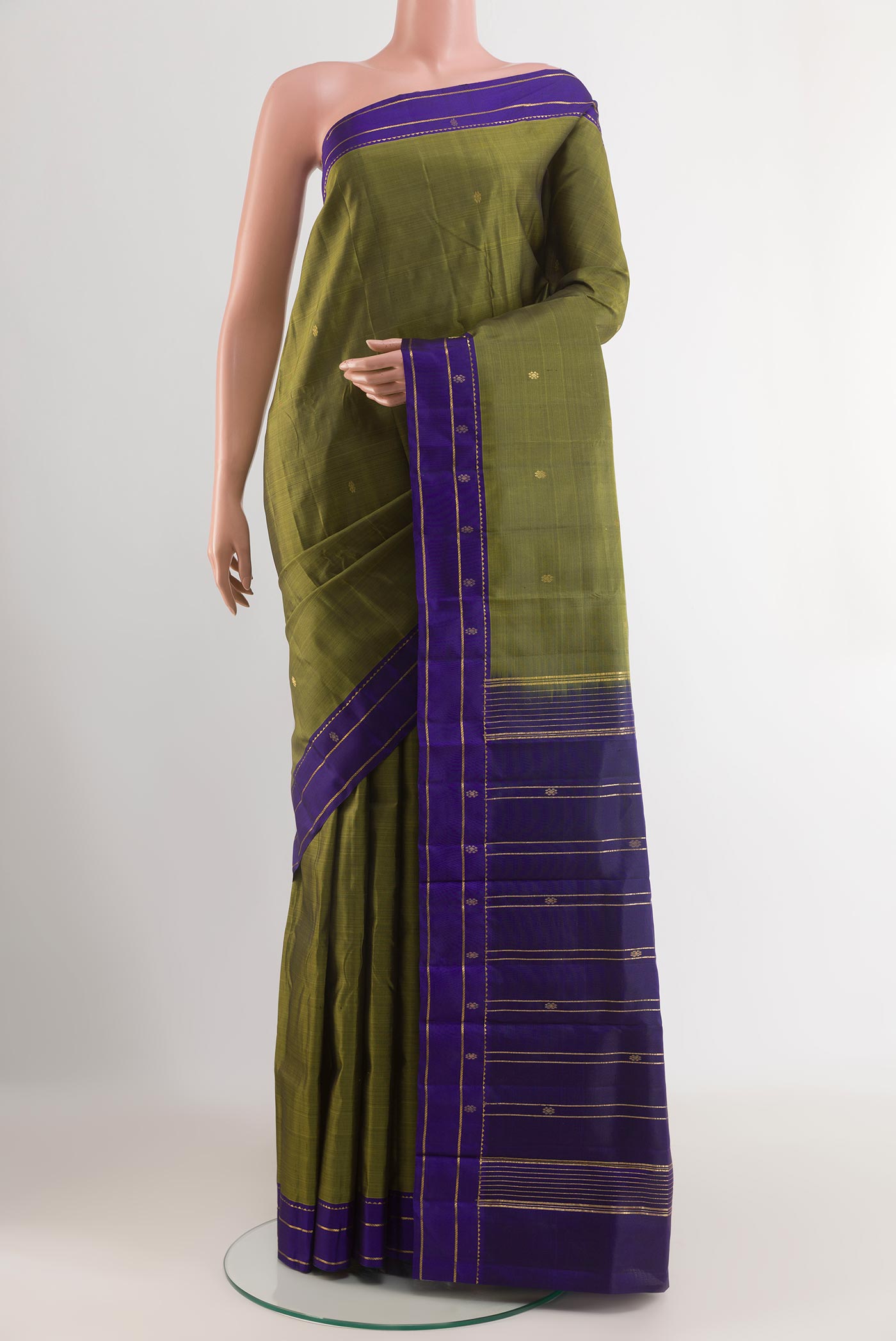 Mehandi Green Kanchipuram Silk Saree with Zari Butta on the body and Zari Border.  displayed on a mannequin