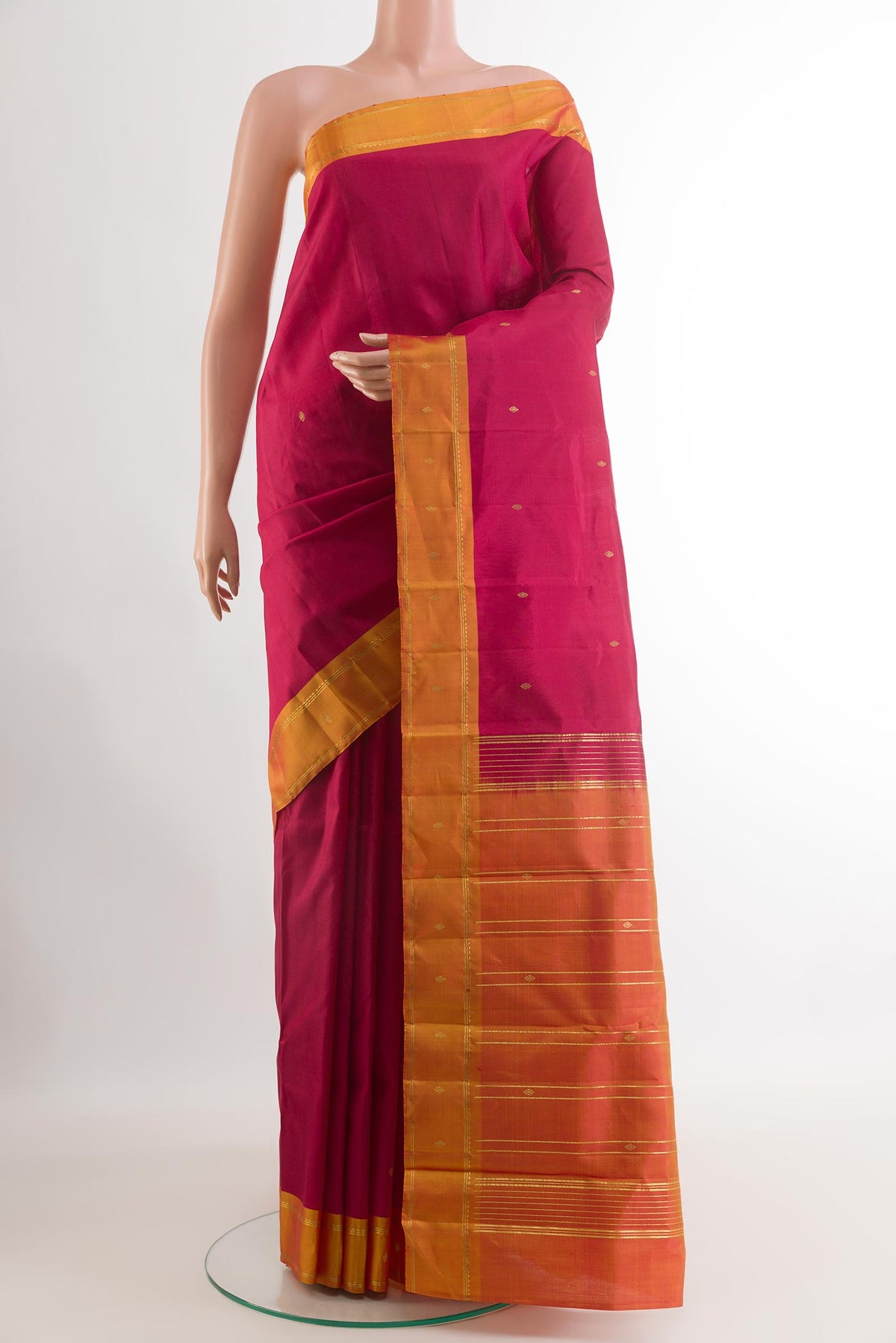 Dark Pink Kanchipuram Silk Saree with Zari Butta on the body and Zari Border.  displayed on a mannequin