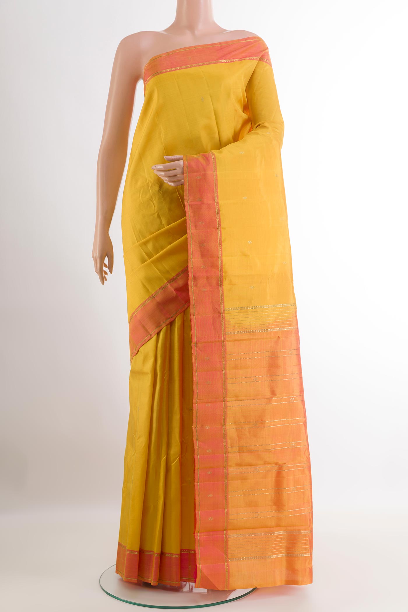 Yellow Kanchipuram Silk Saree with Zari Butta on the body and Zari Border.  displayed on a mannequin