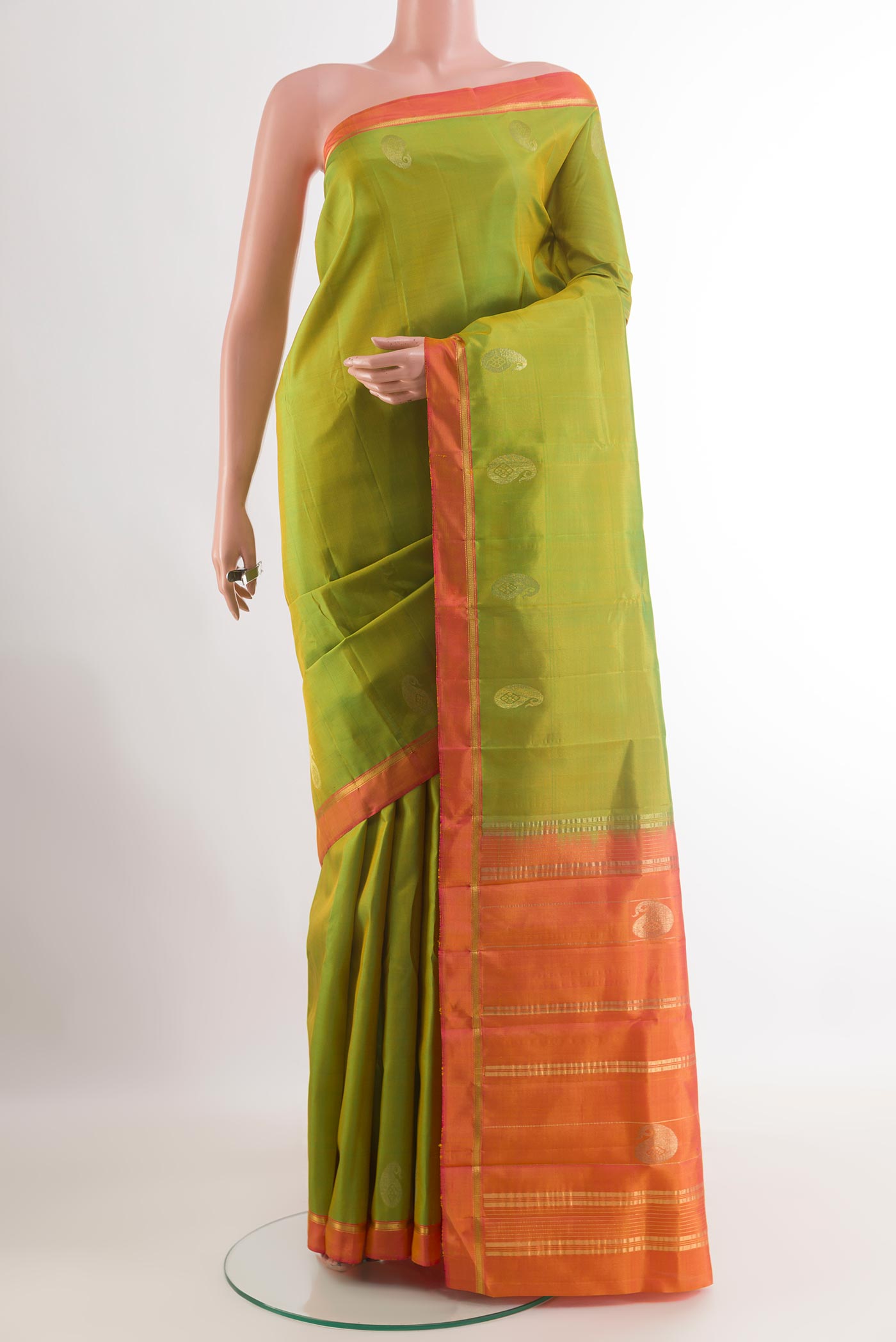 Green Kanchipuram Silk Saree with Zari Butta on the body and Zari Border.  displayed on a mannequin