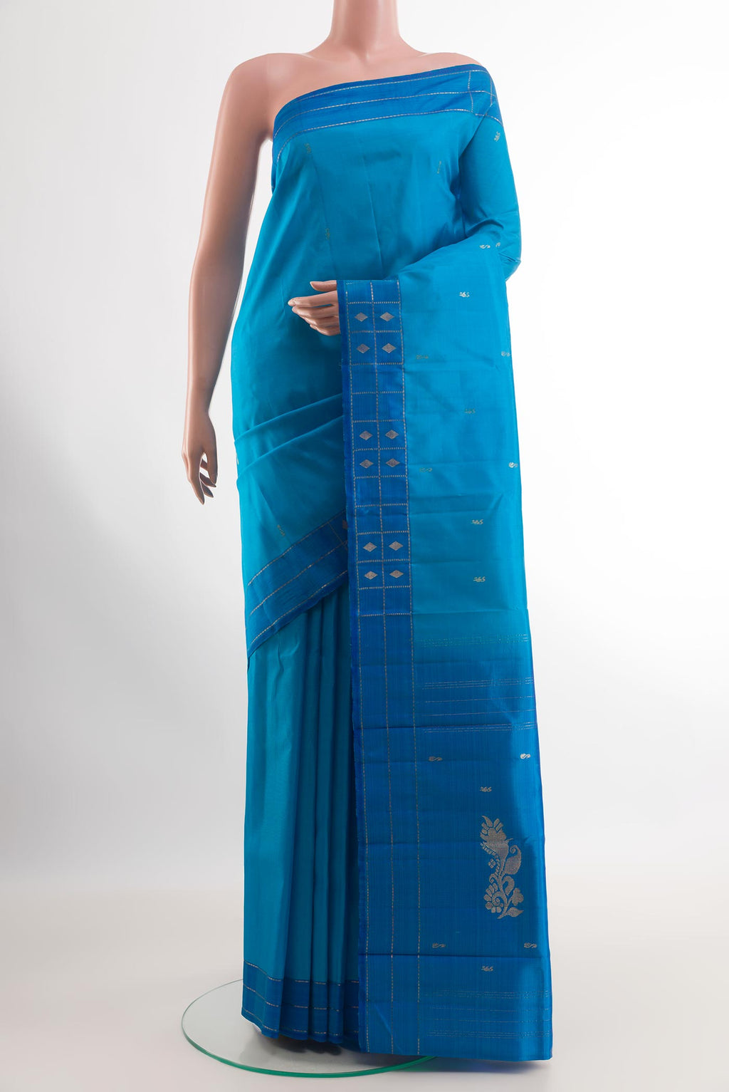 Blue Kanchipuram Silk Saree with Zari Butta on the body and Zari Border.  displayed on a mannequin