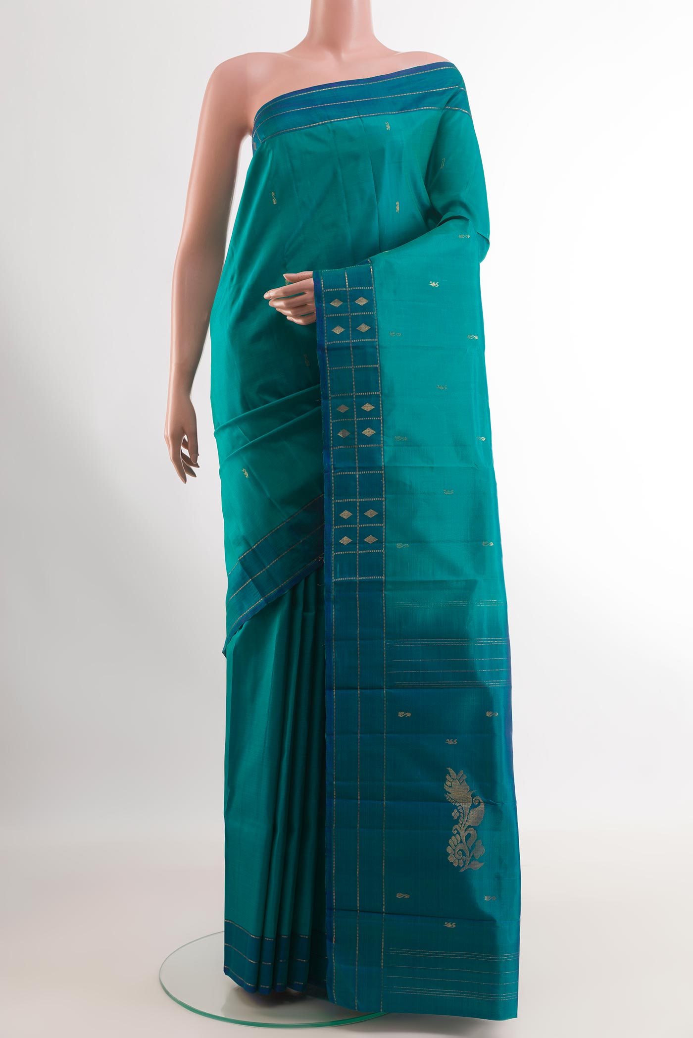 Sea Green Kanchipuram Silk Saree with Zari Butta on the body and Zari Border.  displayed on a mannequin