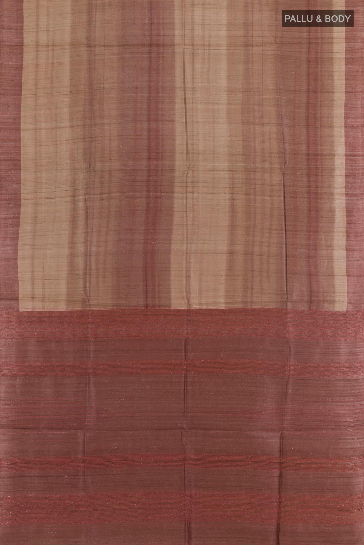 Flat view of Beige Tussar Saree with Printed design on the body and Zari Border. 