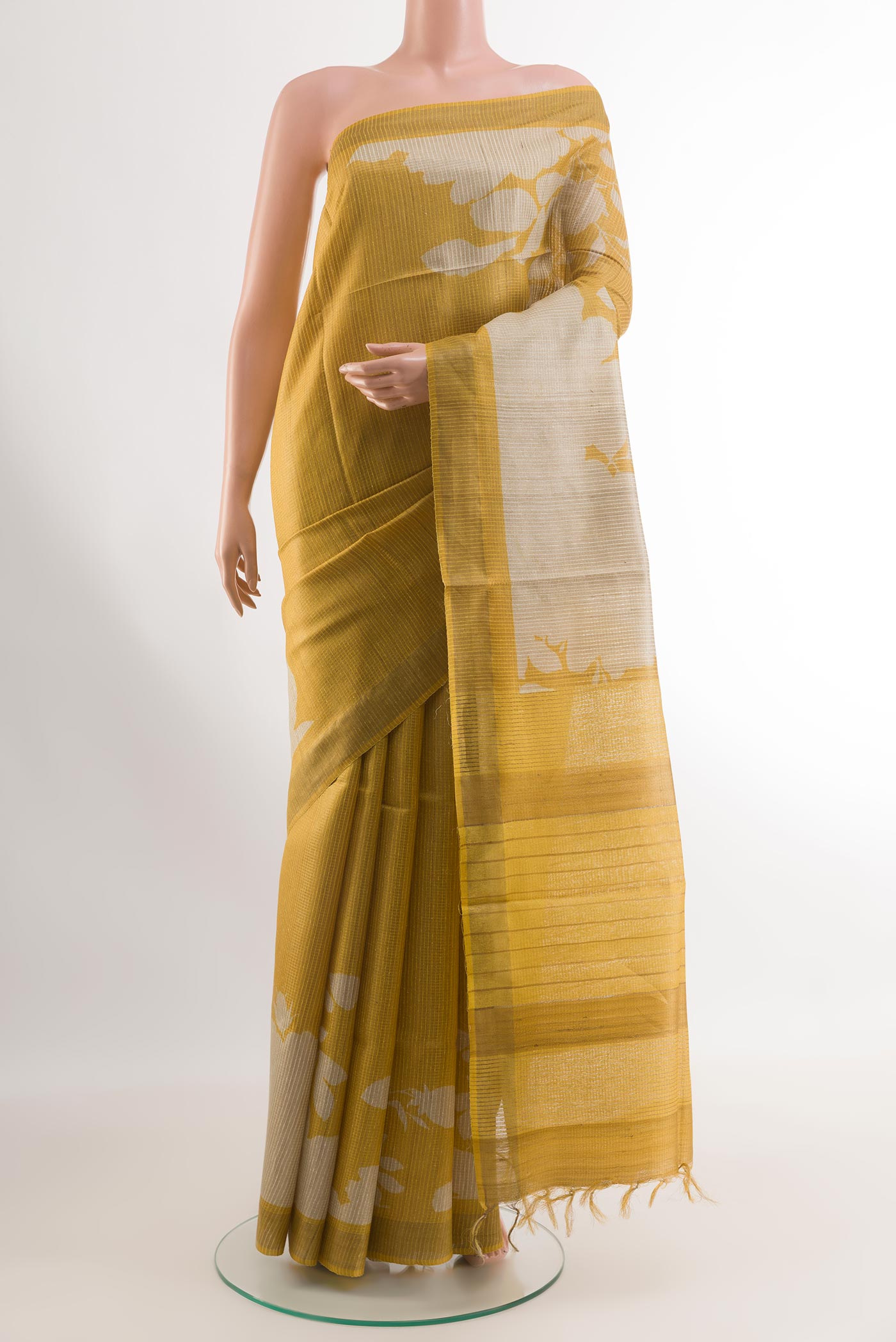 Yellow Tussar Silk Saree with Printed design on the body and Printed Border.  displayed on a mannequin