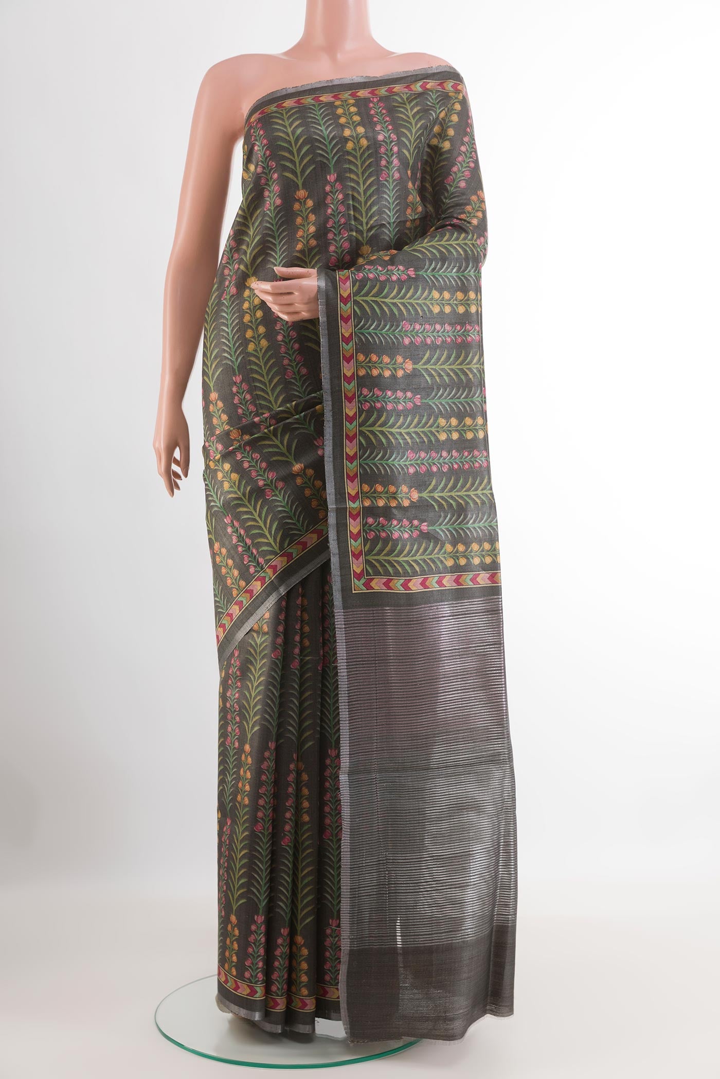 Grey Tussar Saree with Printed design on the body and Zari Border.  displayed on a mannequin