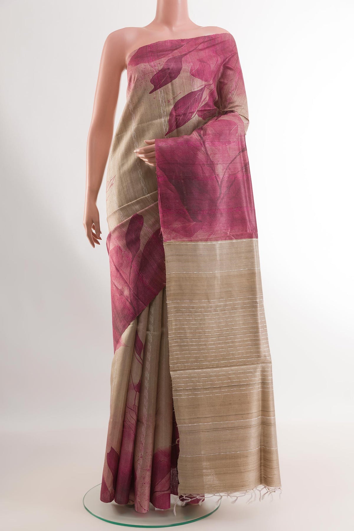 Beige Tussar Silk Saree with Printed design on the body and Printed Border.  displayed on a mannequin