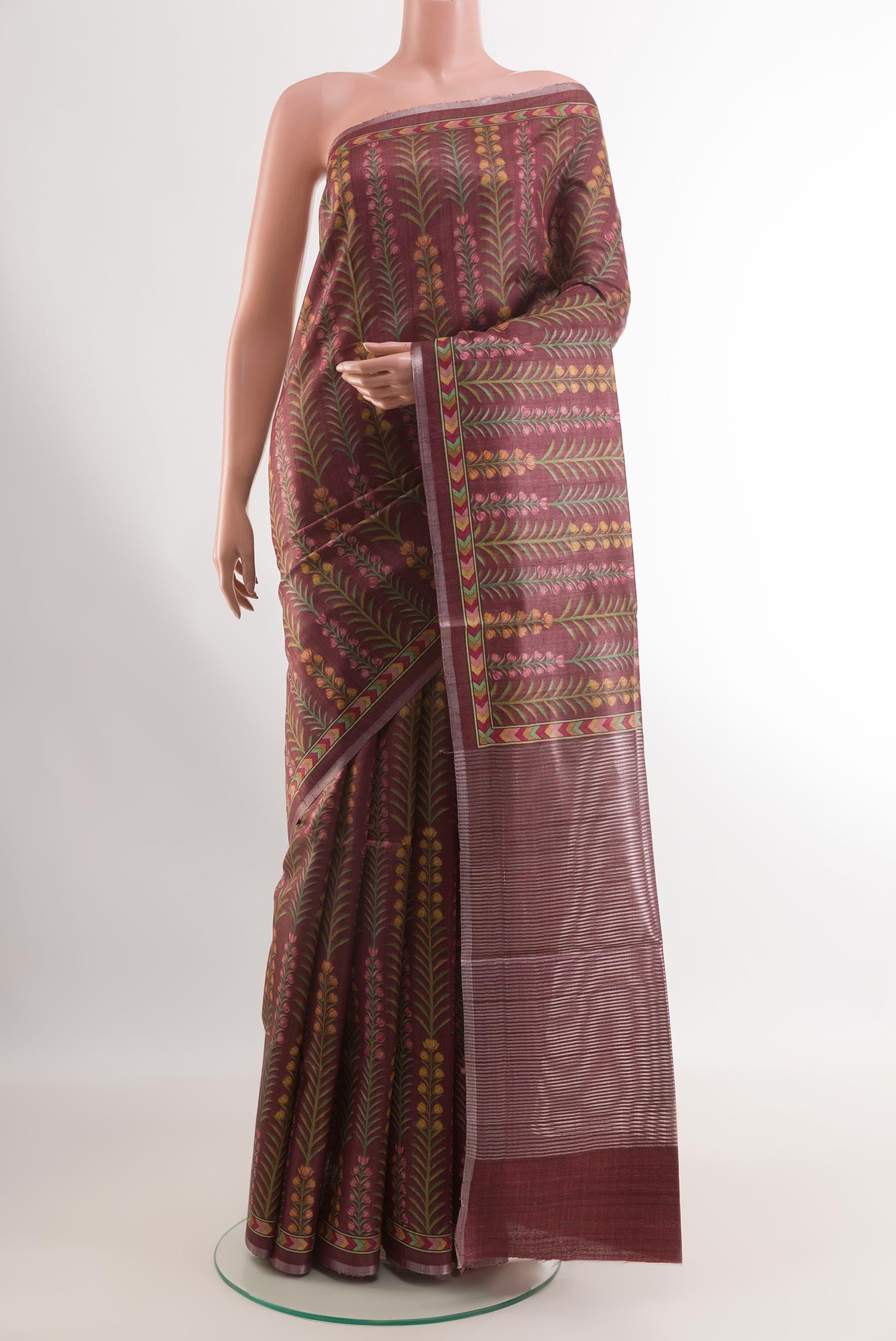 Magenta Tussar Silk Saree with Printed design on the body and Printed Border.  displayed on a mannequin