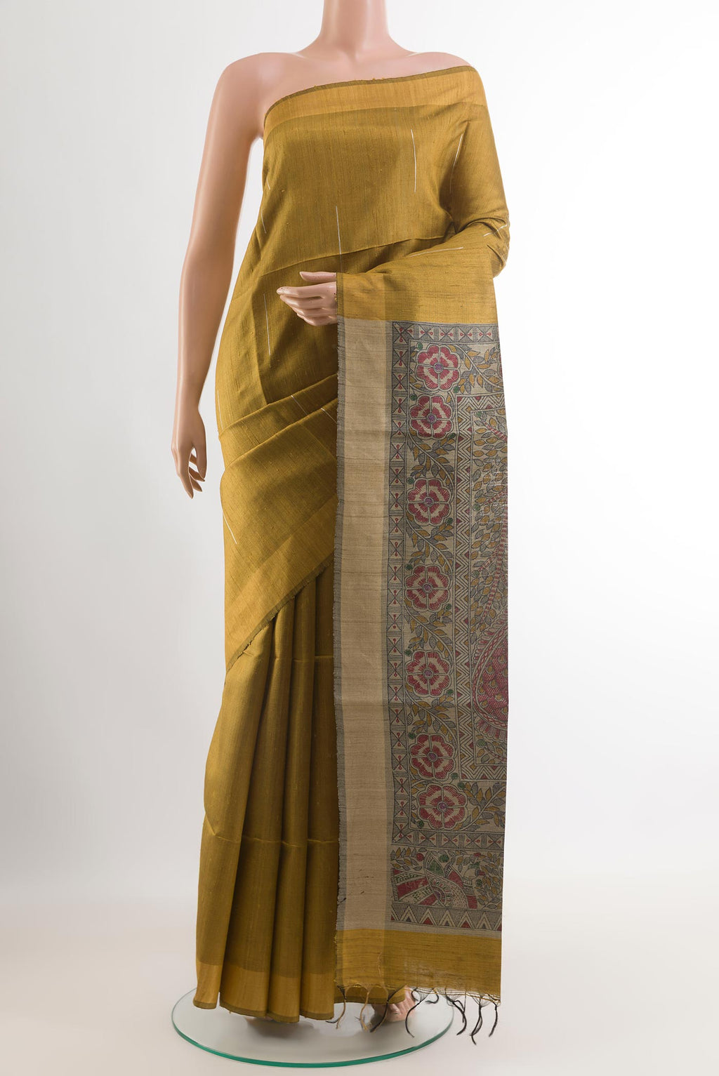 Mustard Tussar Saree with Printed design on the body and Zari Border.  displayed on a mannequin
