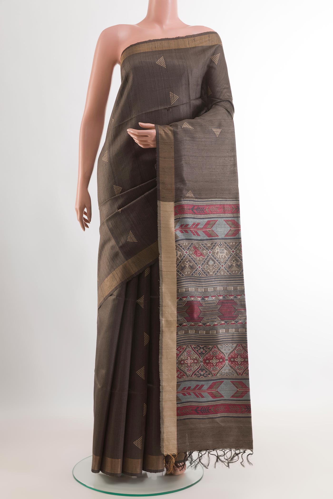 Grey Tussar Saree with Printed design on the body and Zari Border.  displayed on a mannequin