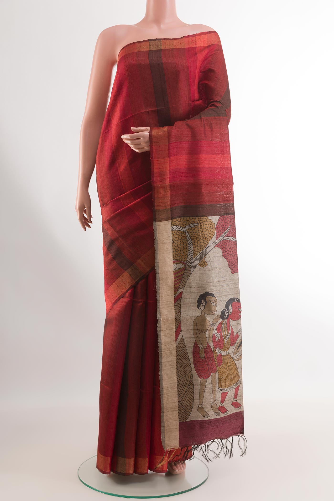 Red Tussar Silk Saree with Stripes on the body and Printed Border.  displayed on a mannequin