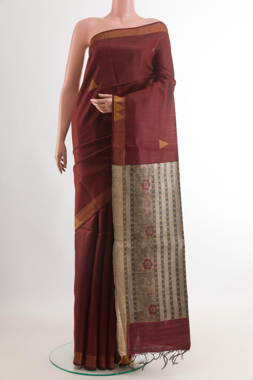 Maroon Tussar Saree with Printed design on the body and Zari Border.  displayed on a mannequin
