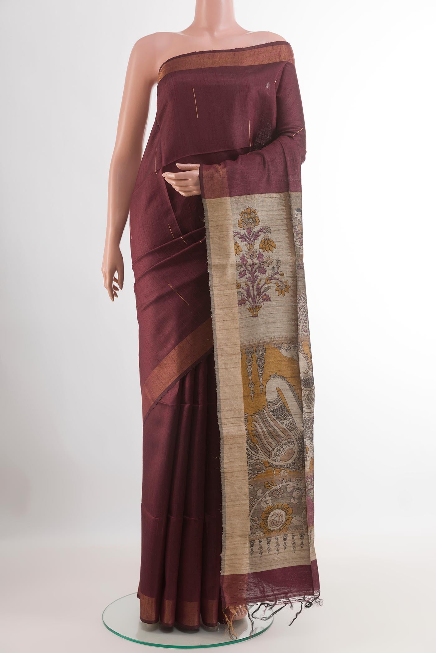 Maroon Tussar Saree with Zari Butta on the body and Without Border.  displayed on a mannequin