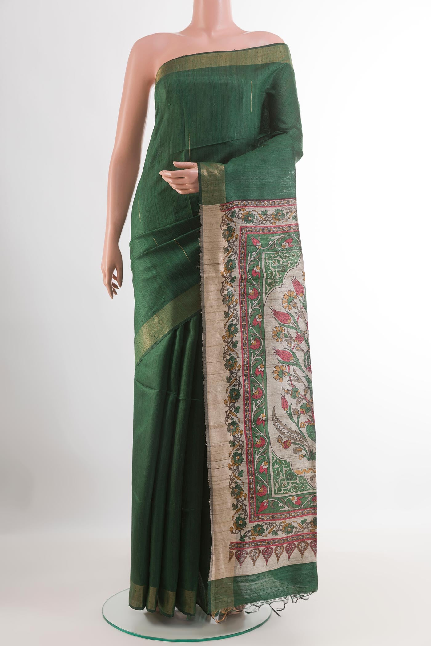 Green Tussar Saree with Zari Butta on the body and Zari Border.  displayed on a mannequin
