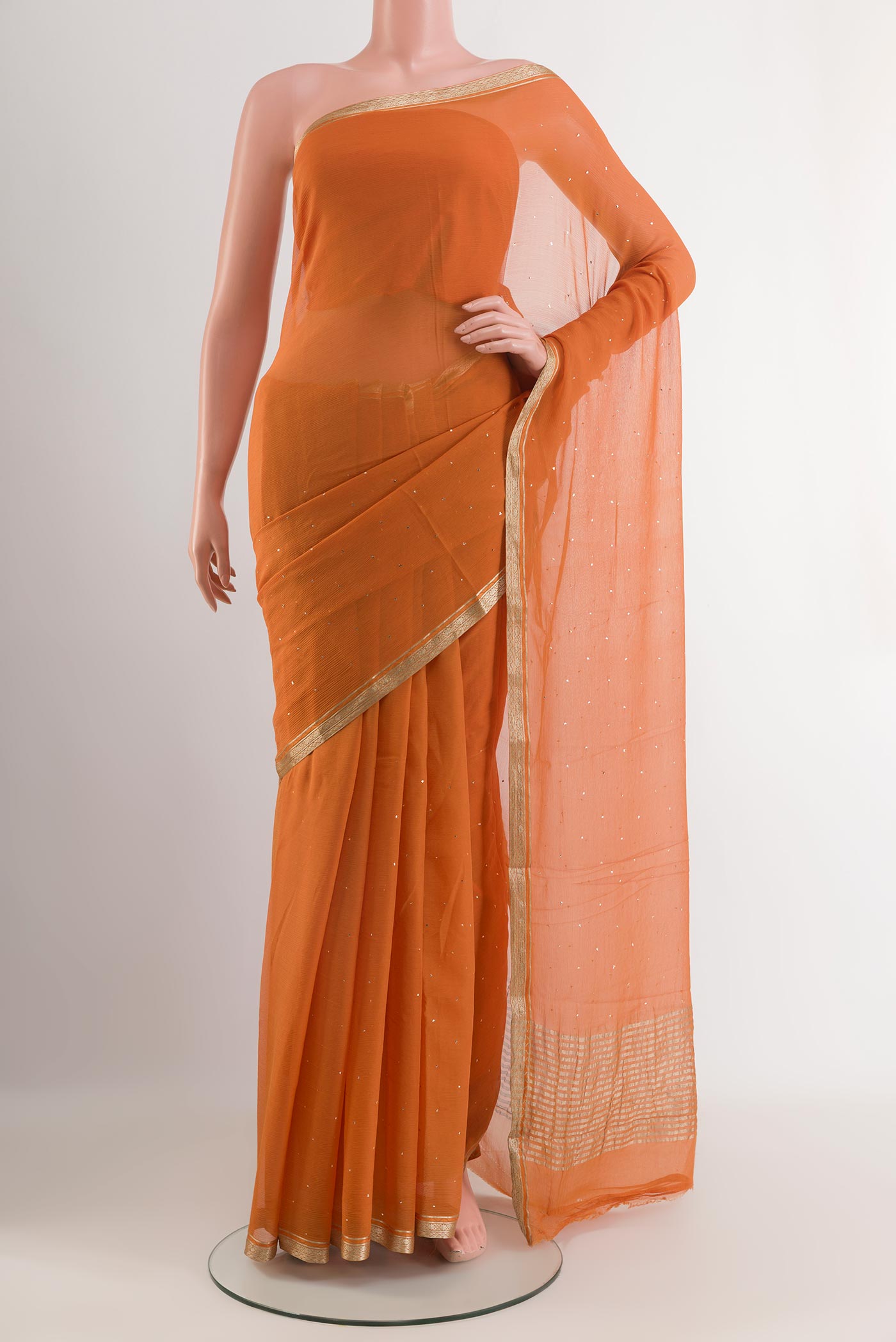 Orange Mysore Chiffon Saree with Zari Butta on the body and Zari Border.  displayed on a mannequin