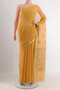Yellow Mysore Chiffon Saree with Zari Butta on the body and Zari Border.  displayed on a mannequin