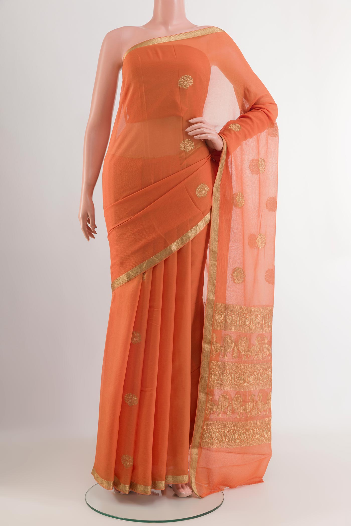 Orange Mysore Chiffon Saree with Zari Butta on the body and Zari Border.  displayed on a mannequin