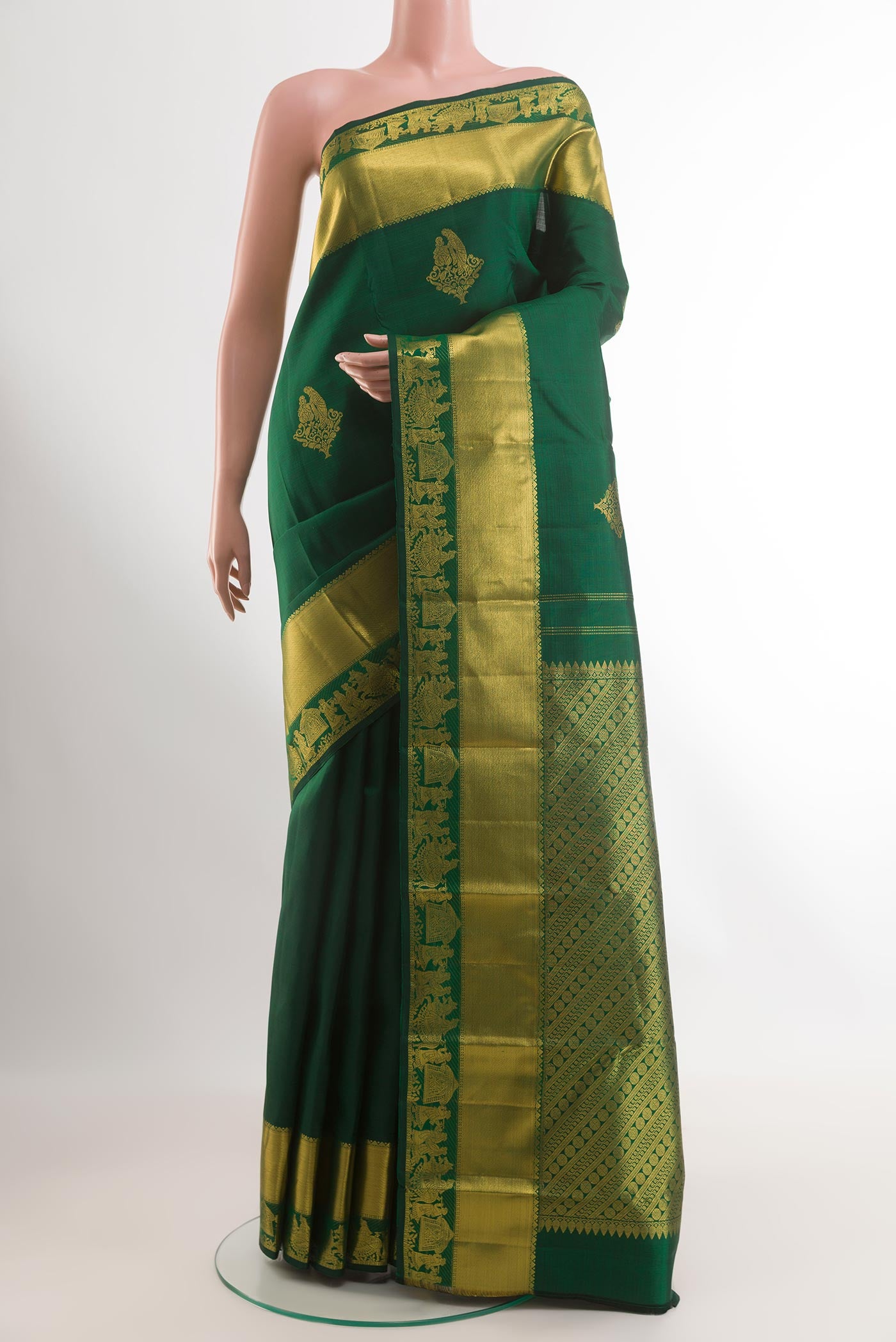 Green Kanchipuram Silk Saree with Zari Butta on the body and Zari Border.  displayed on a mannequin