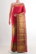 Peach Kanchipuram Silk Saree with Zari Butta on the body and Zari Border.  displayed on a mannequin