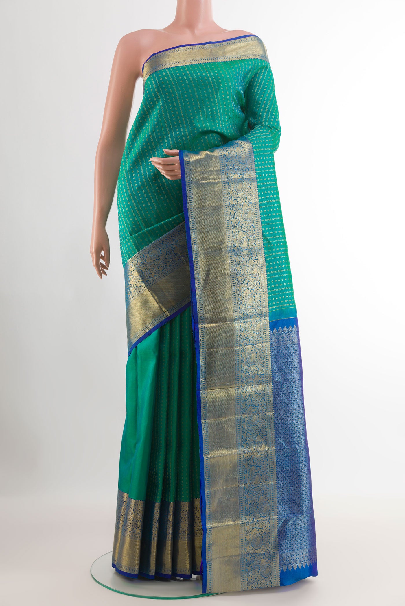 Green Tussar Silk Saree with Zari Butta on the body and Zari Border.  displayed on a mannequin