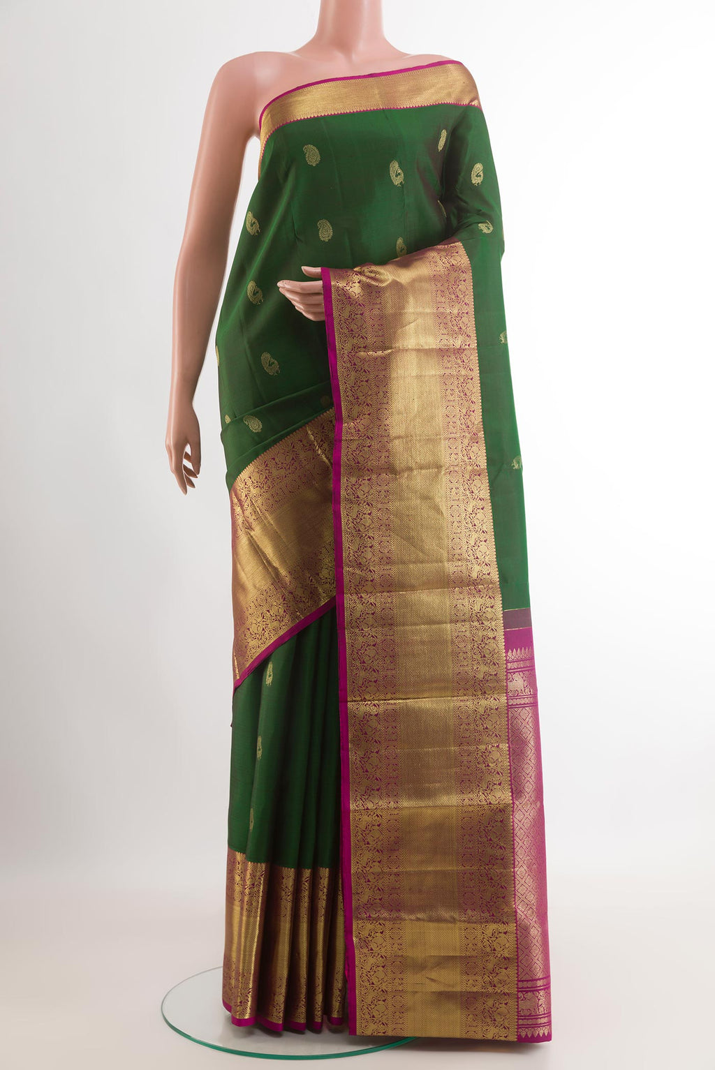 Green Kanchipuram Silk Saree with Zari Butta on the body and Zari Border.  displayed on a mannequin