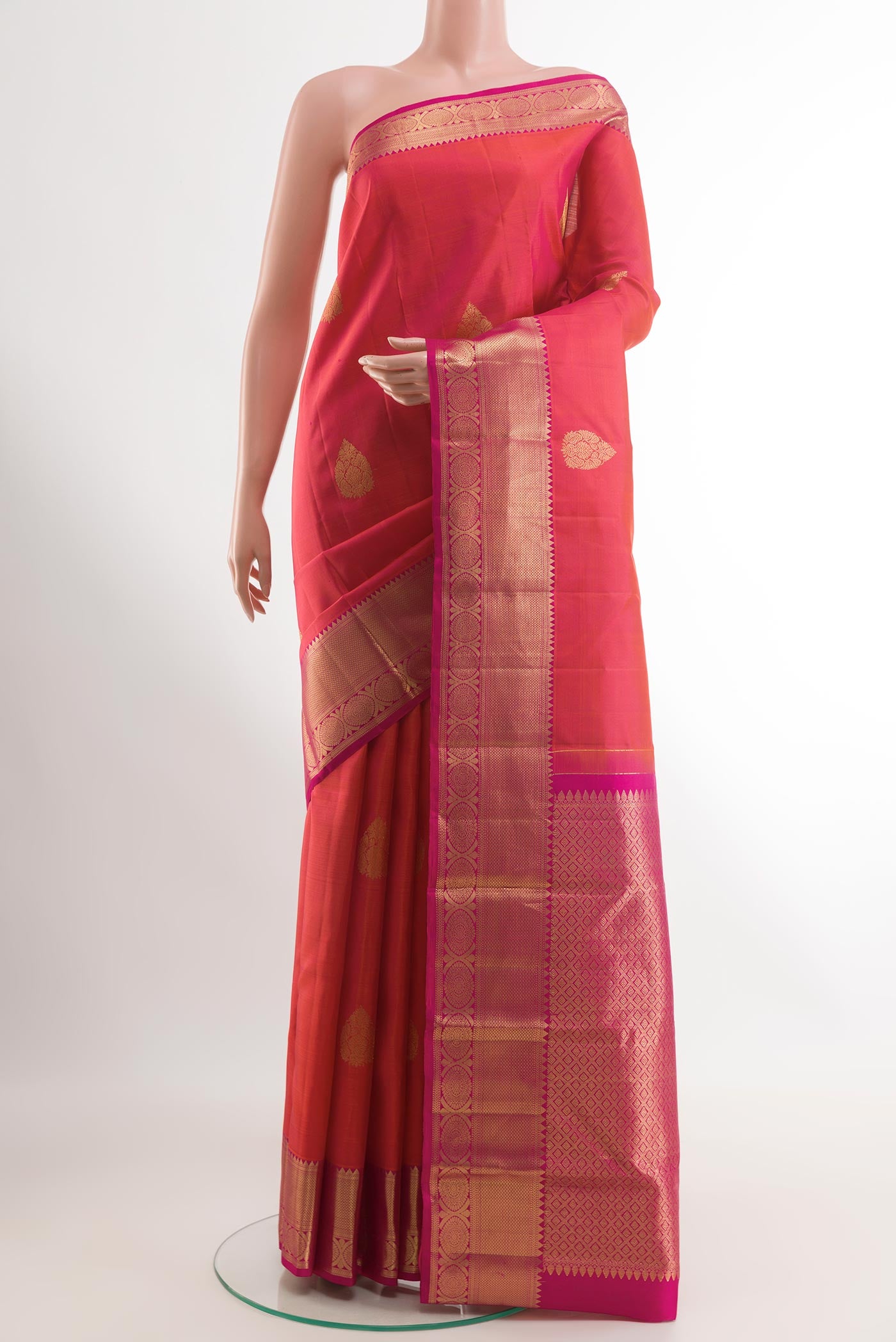 Pink Kanchipuram Silk Saree with Zari Butta on the body and Zari Border.  displayed on a mannequin