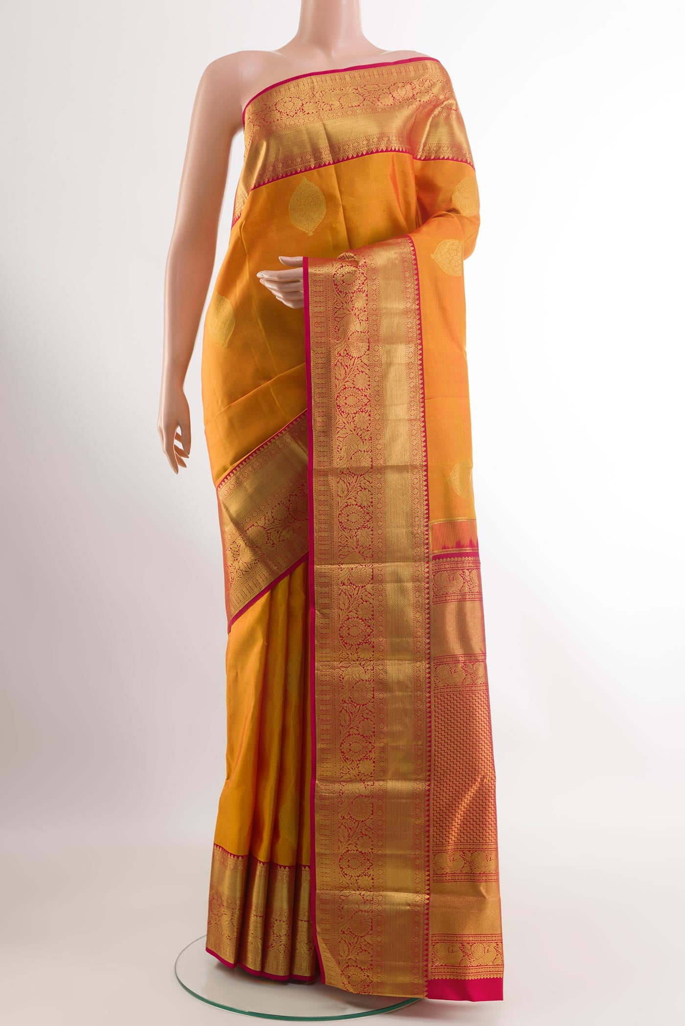 Yellow Kanchipuram Silk Saree with Zari Butta on the body and Zari Border.  displayed on a mannequin