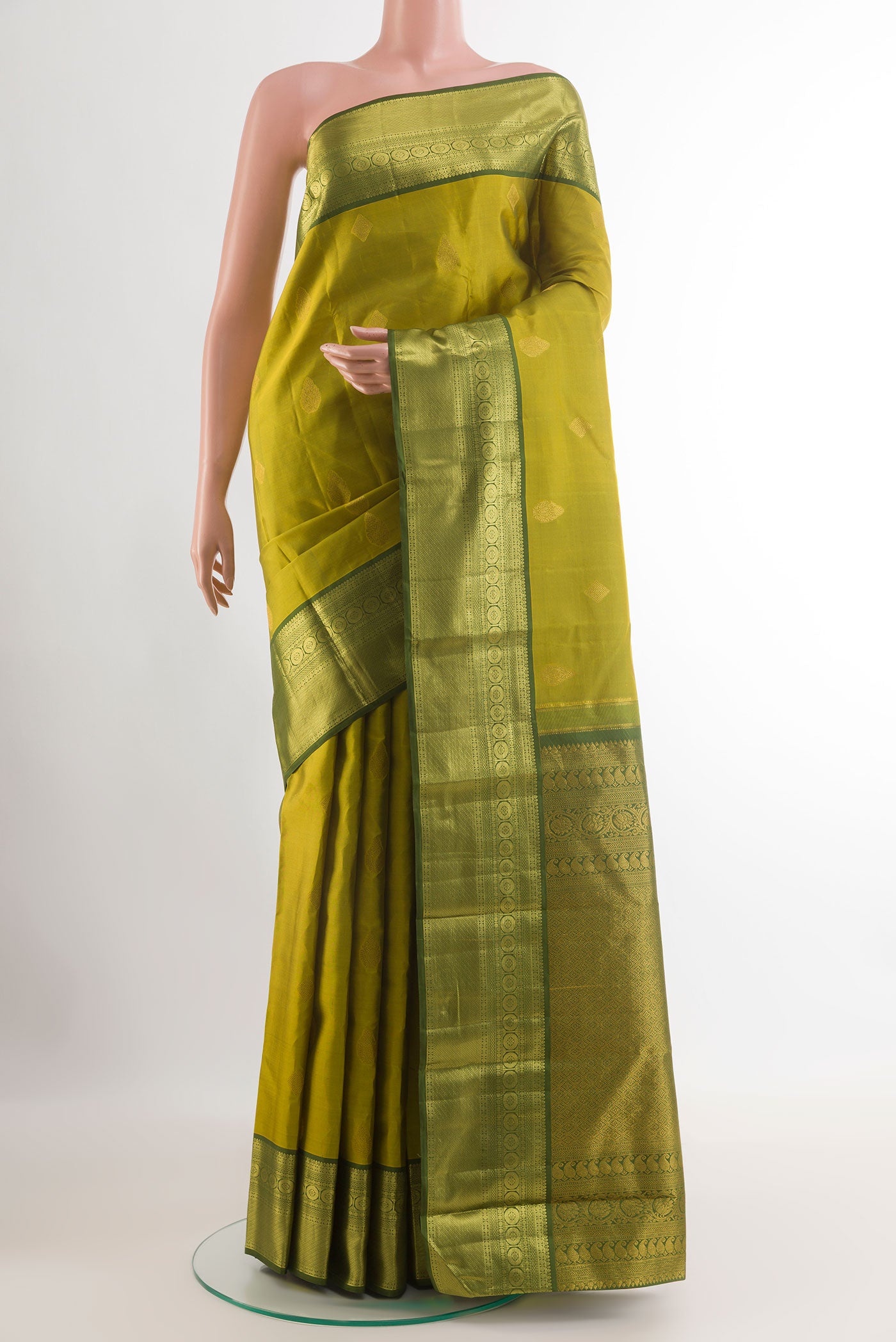 Light Green Tussar Silk Saree with Zari Butta on the body and Zari Border.  displayed on a mannequin
