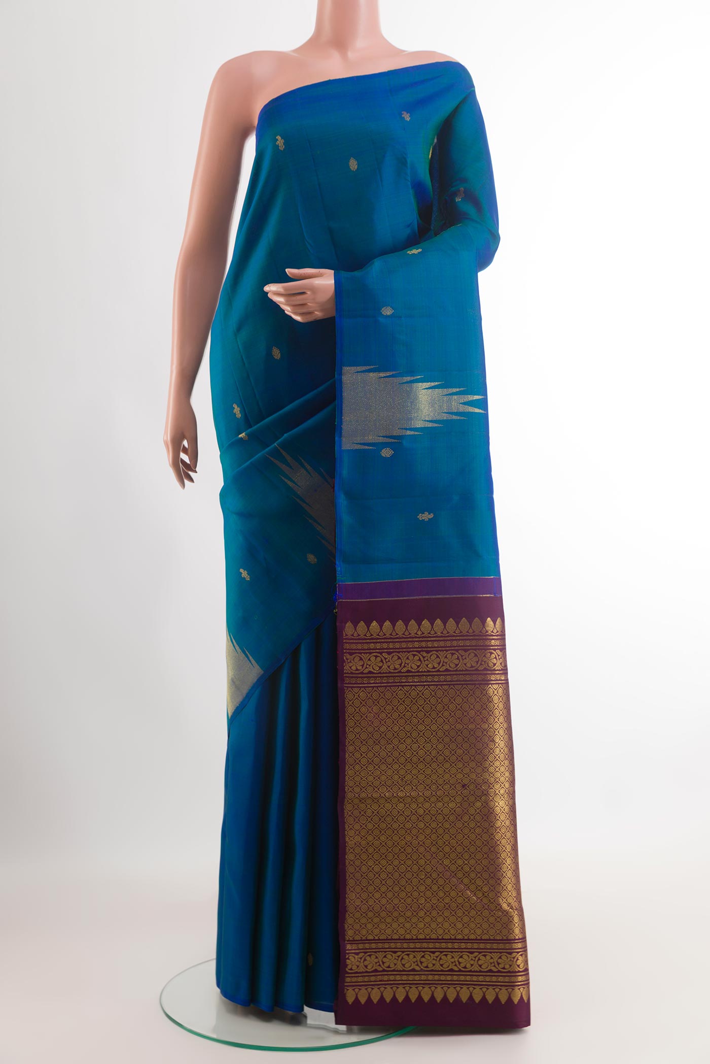 Blue Kanchipuram Silk Saree with Zari Butta on the body and Zari Border.  displayed on a mannequin