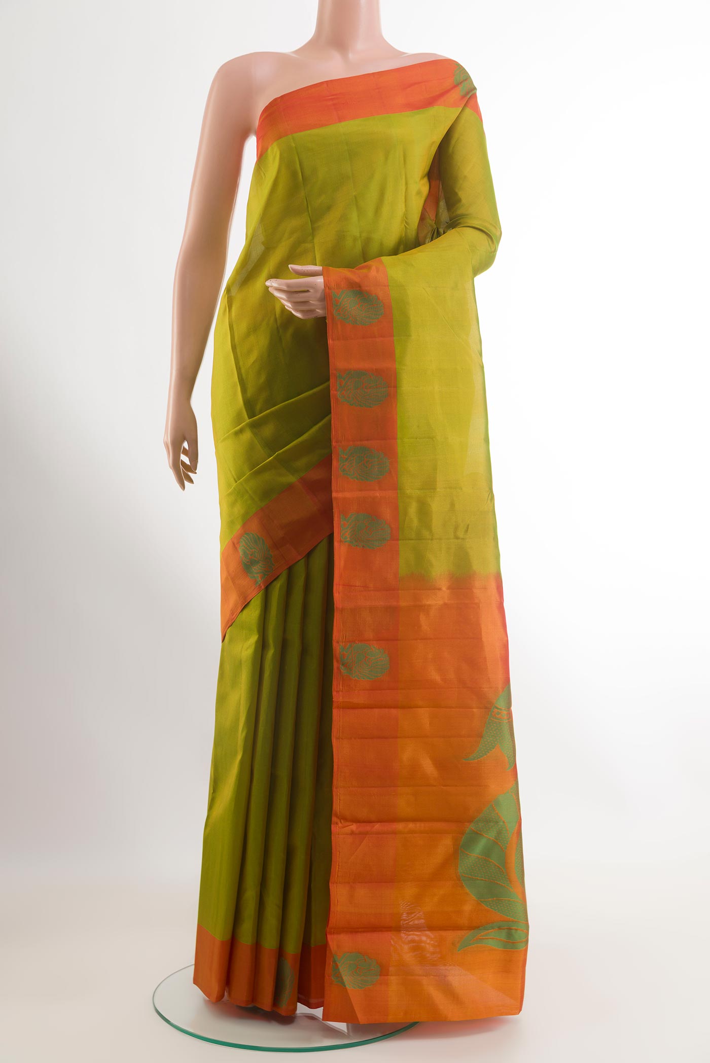 Green Kanjivaram Silk Saree with Zari Butta on the body and Thread Border.  displayed on a mannequin