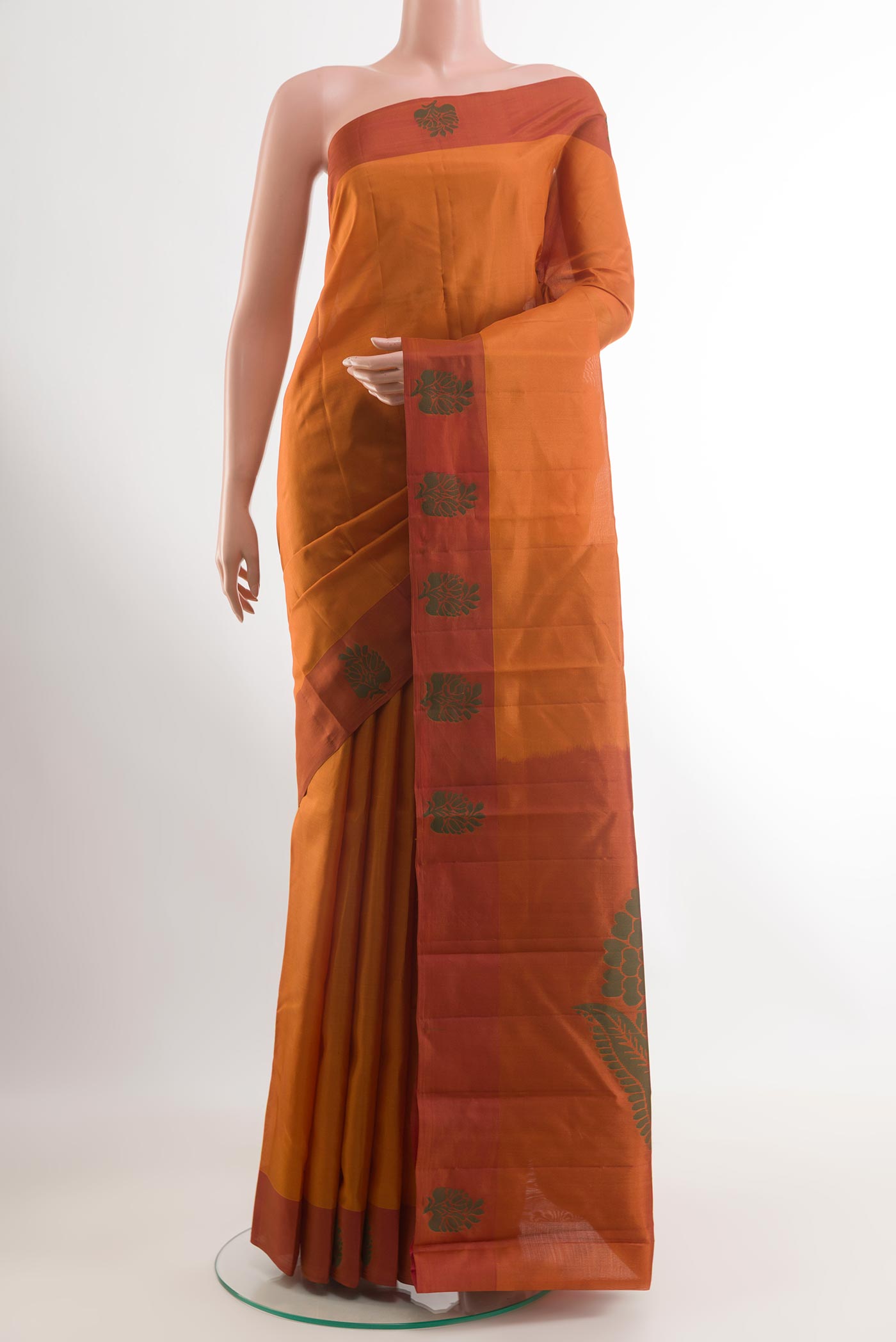 Brick Orange Kanjivaram Silk Saree with Zari Butta on the body and Thread Border.  displayed on a mannequin
