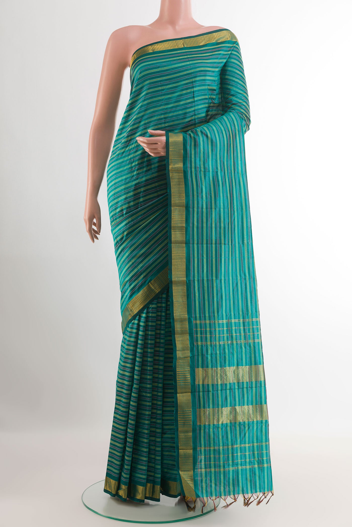 Green Kanchipuram Silk Saree with Stripes on the body and Zari Border.  displayed on a mannequin