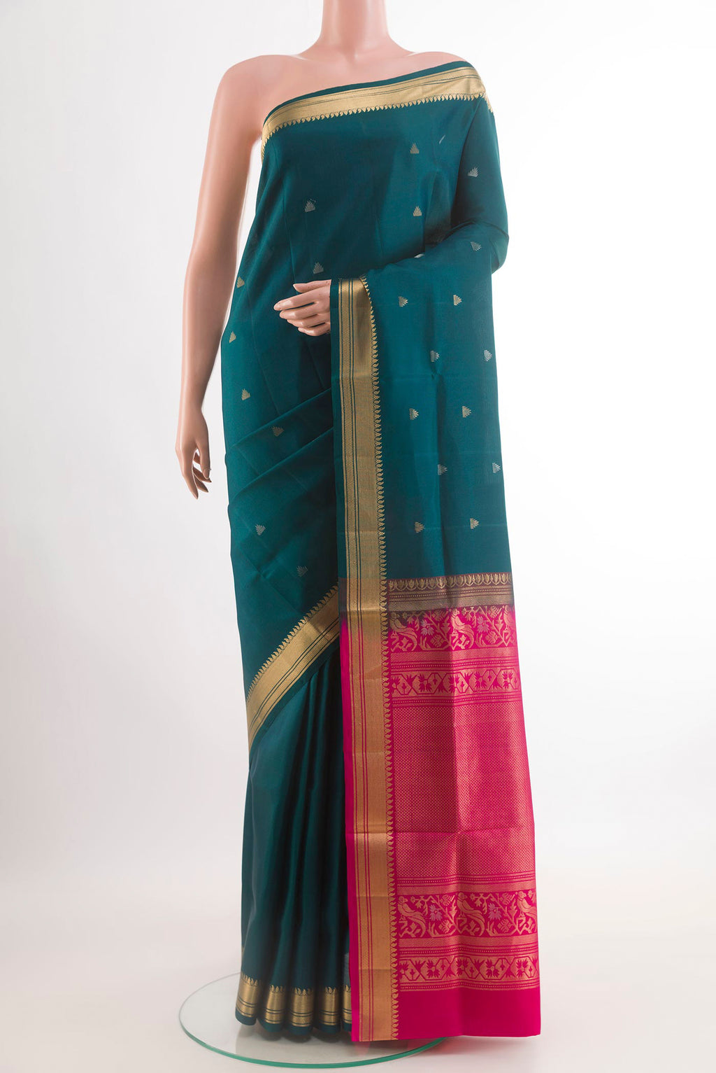 Teal Soft Silk Saree with Zari Butta on the body and Zari Border.  displayed on a mannequin