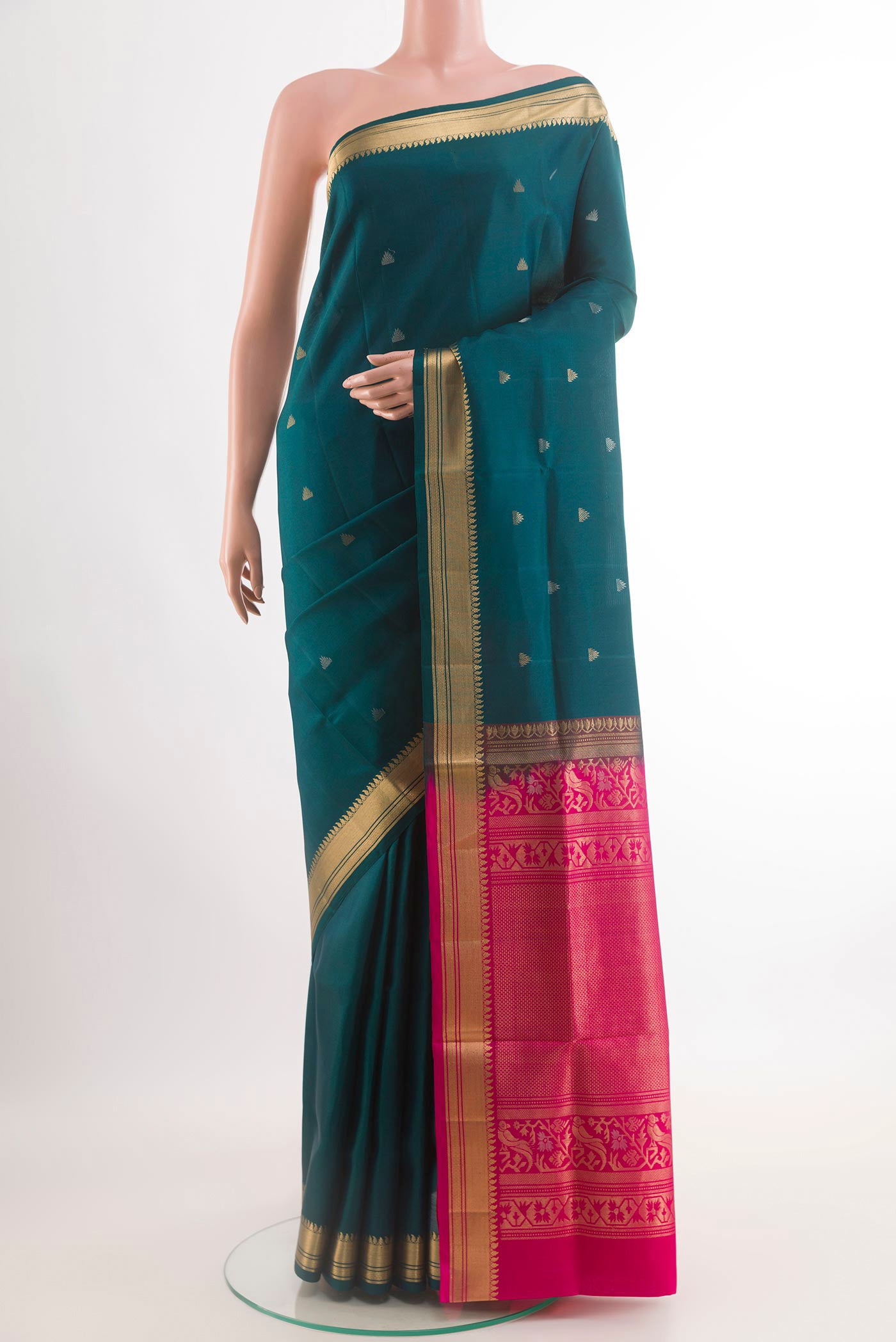 Teal Soft Silk Saree with Zari Butta on the body and Zari Border.  displayed on a mannequin