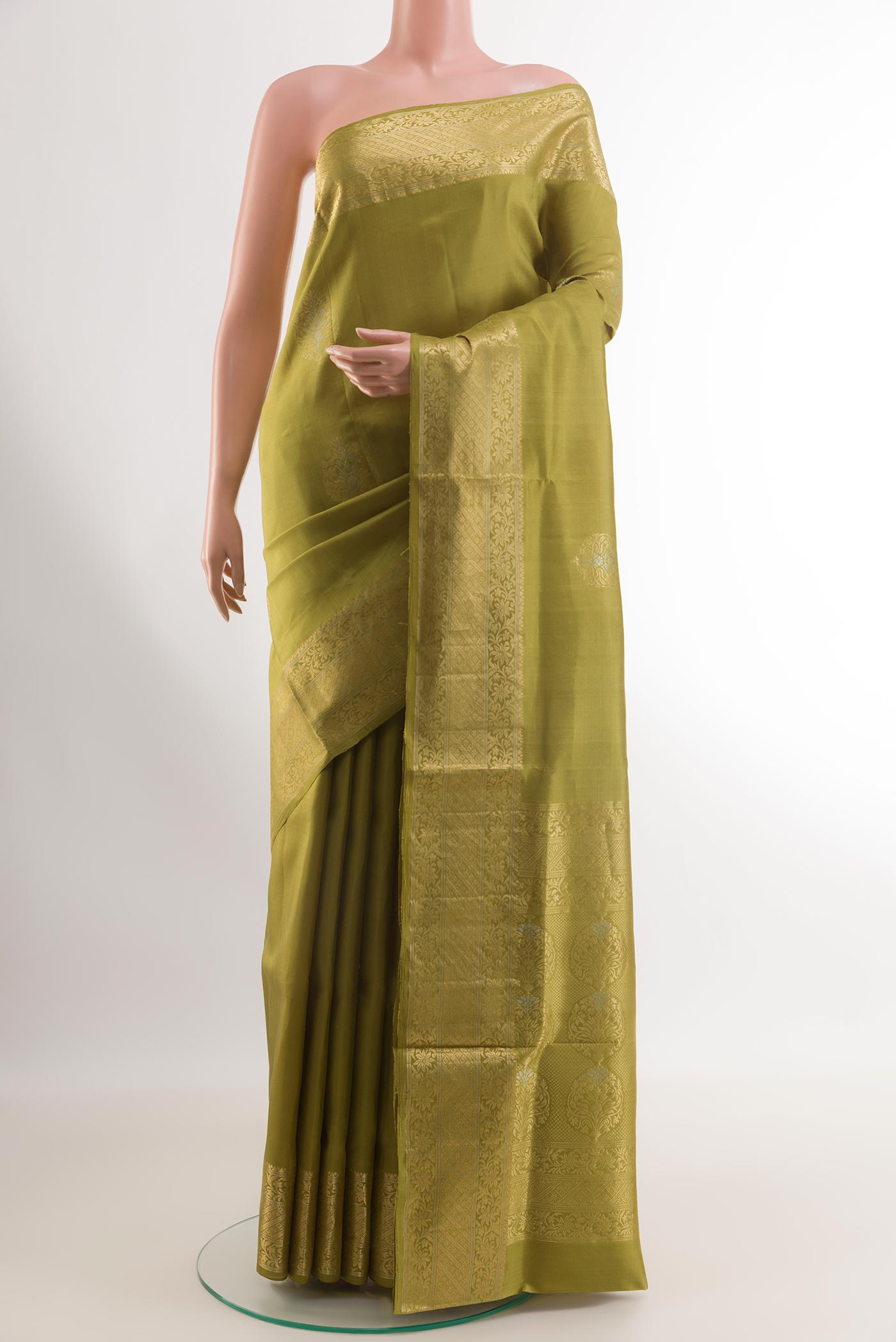 Mehandi Green Soft Silk Saree with Zari Butta on the body and Zari Border.  displayed on a mannequin