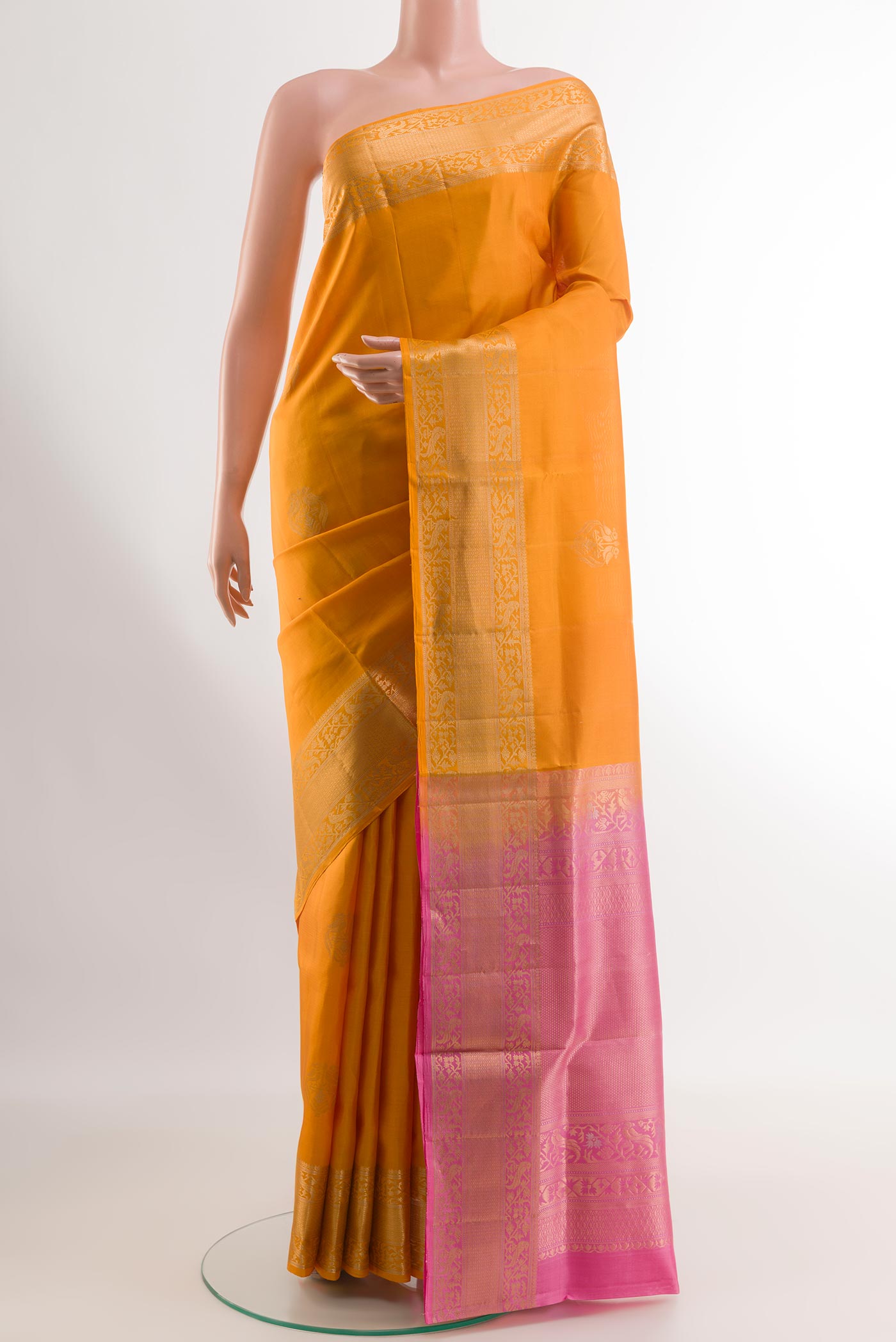 Yellow Soft Silk Saree with Zari Butta on the body and Zari Border.  displayed on a mannequin