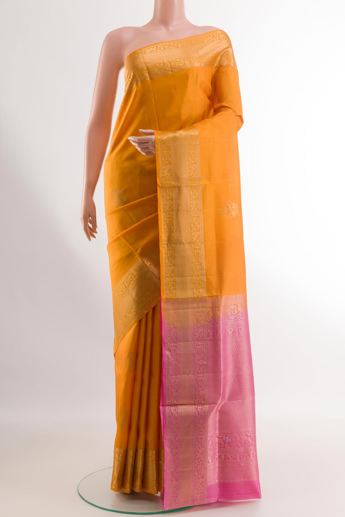 Yellow Soft Silk Saree with Zari Butta on the body and Zari Border.  displayed on a mannequin