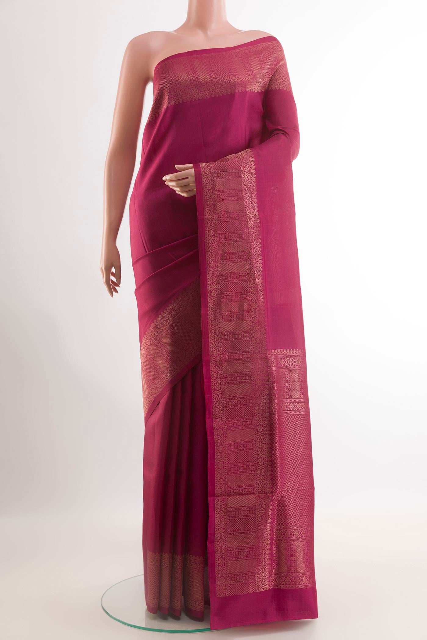 Magenta Soft Silk Saree with Zari Butta on the body and Zari Border.  displayed on a mannequin