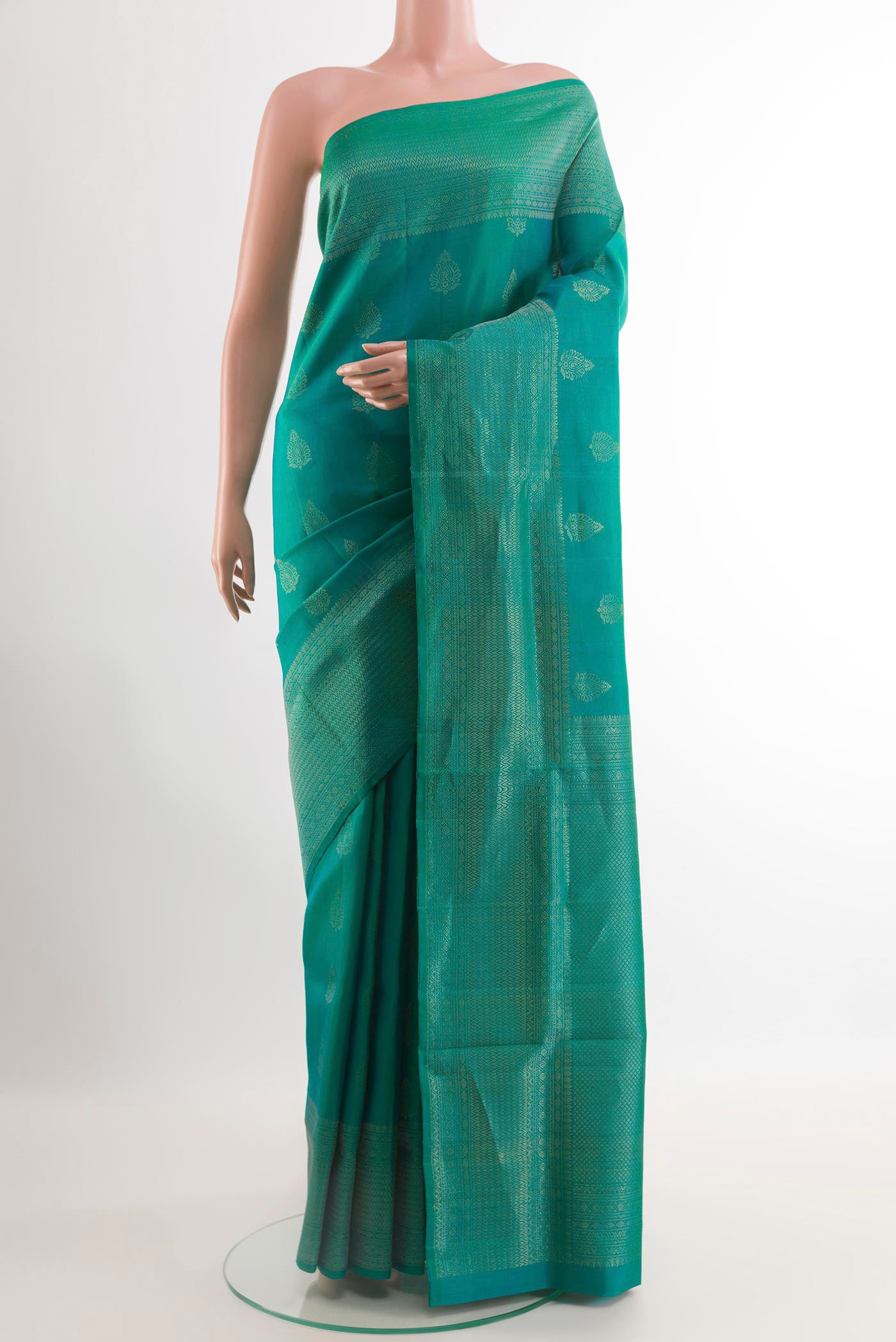 Sea Green Soft Silk Saree with Zari Butta on the body and Zari Border.  displayed on a mannequin