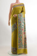 Mehandi Green Tussar Saree with Plain Body and Printed Border.  displayed on a mannequin