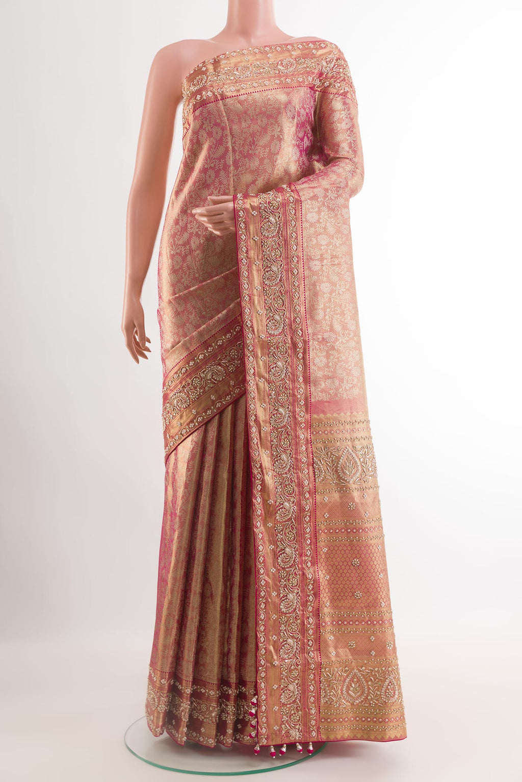 Rose pink Kanjivaram Tissue Silk Saree with Embroidery on the body and Zari Border.  displayed on a mannequin