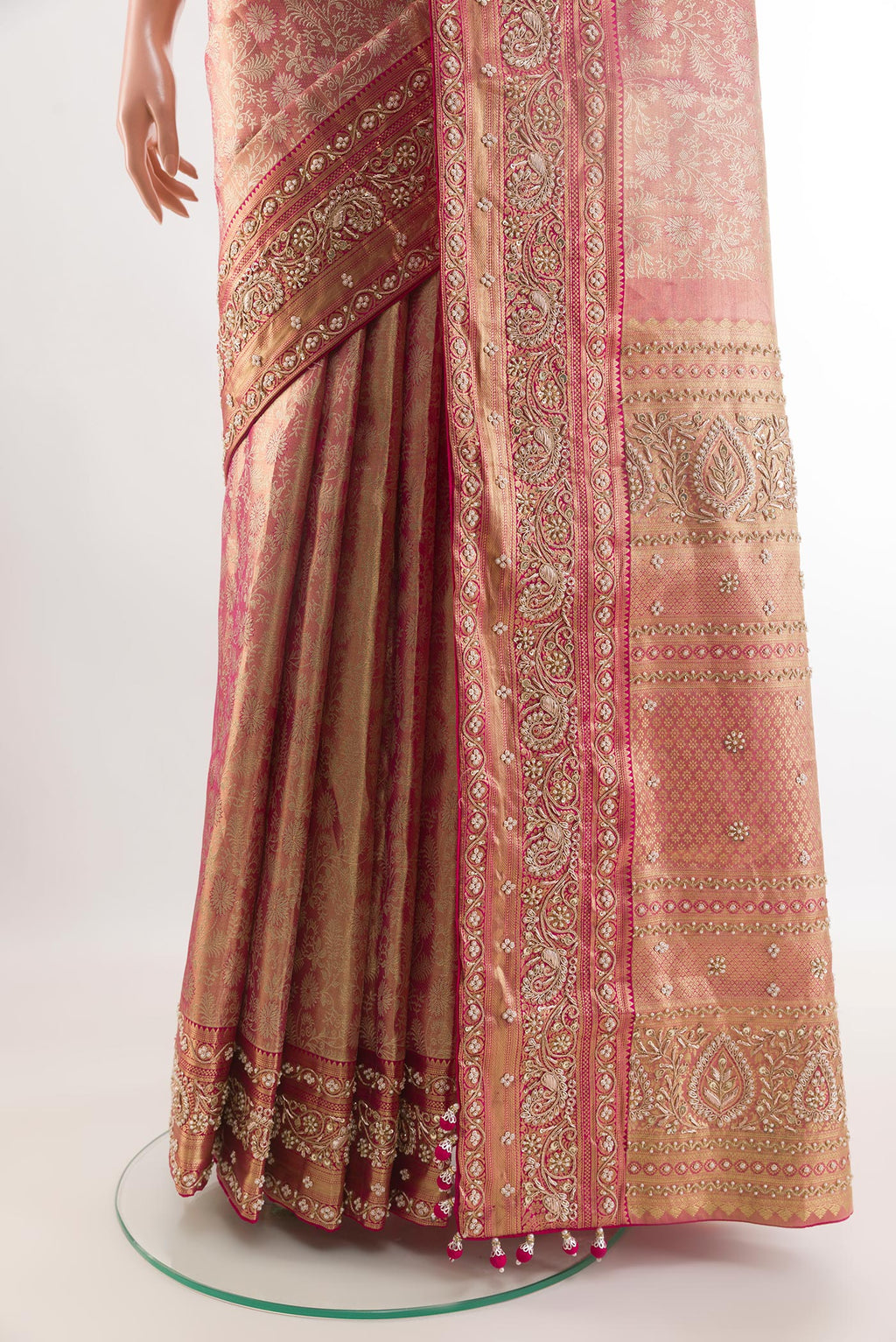 Pleats and pallu of Rose pink Kanjivaram Tissue Silk Saree with Embroidery on the body and Zari Border. 