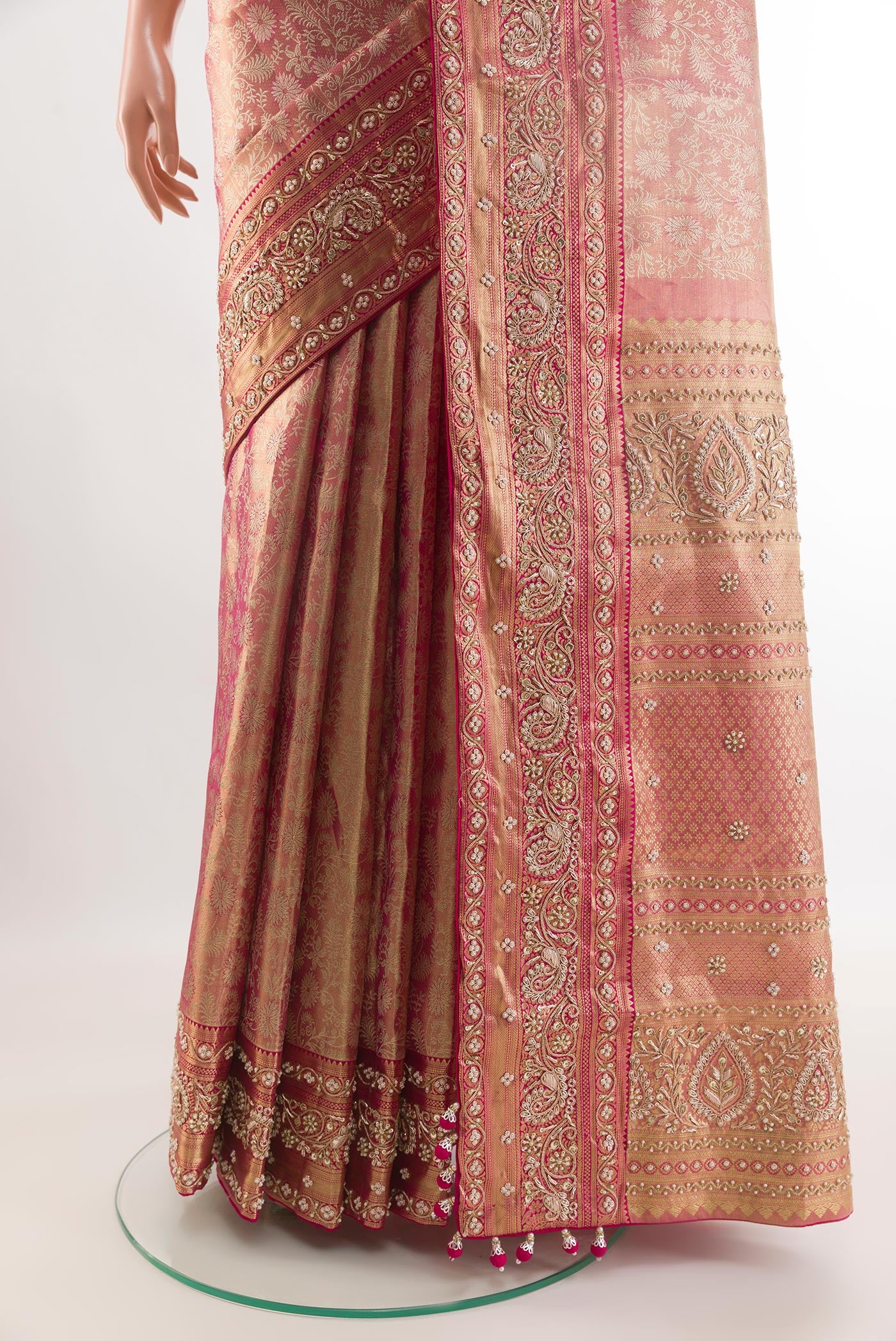 Pleats and pallu of Rose pink Kanjivaram Tissue Silk Saree with Embroidery on the body and Zari Border. 