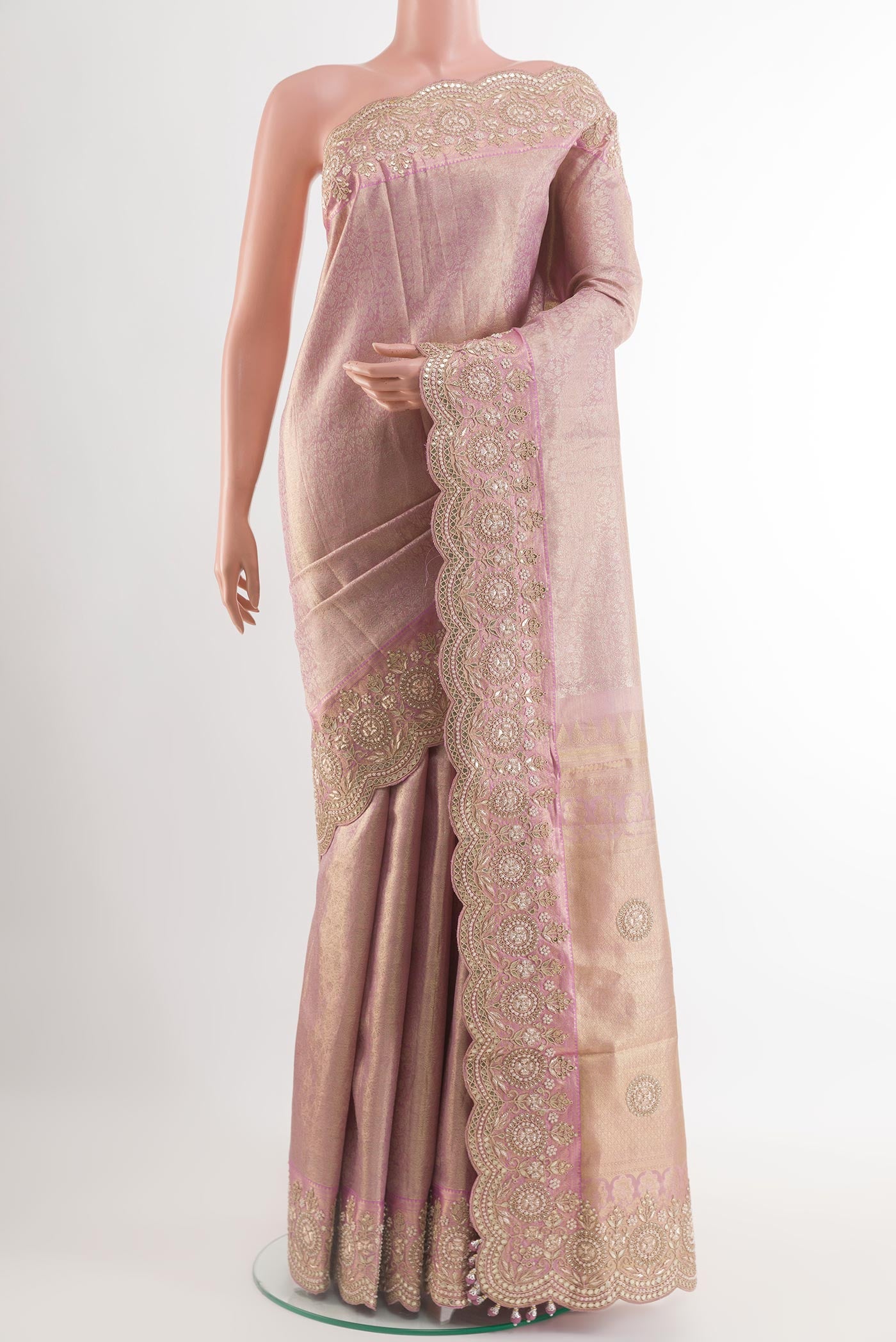 Rose Gold Kanjivaram Tissue Silk Saree with Zari Brocade on the body and Embroidery Border.  displayed on a mannequin