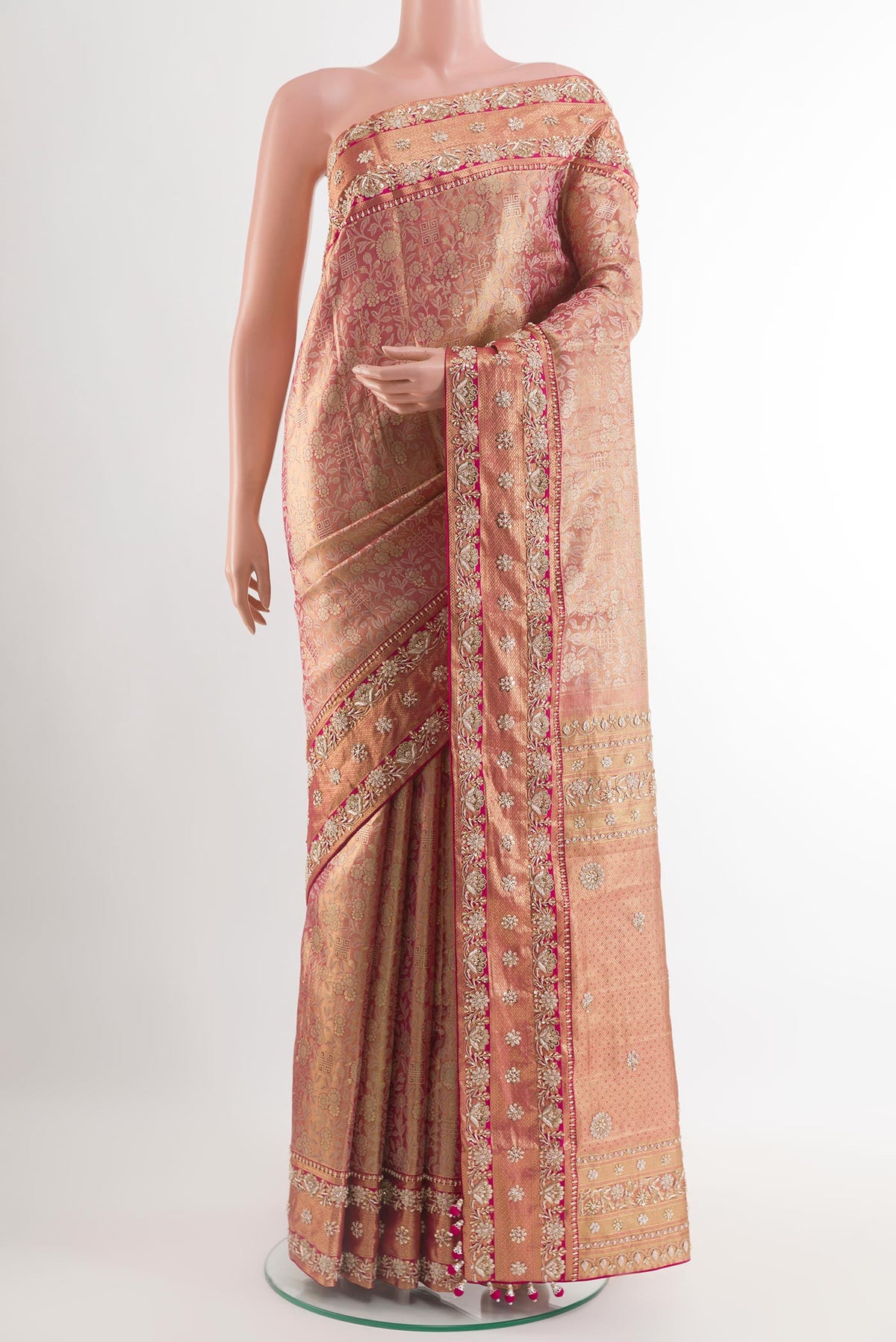 Pink Kanjivaram Tissue Silk Saree with Zari Brocade on the body and Embroidery Border.  displayed on a mannequin