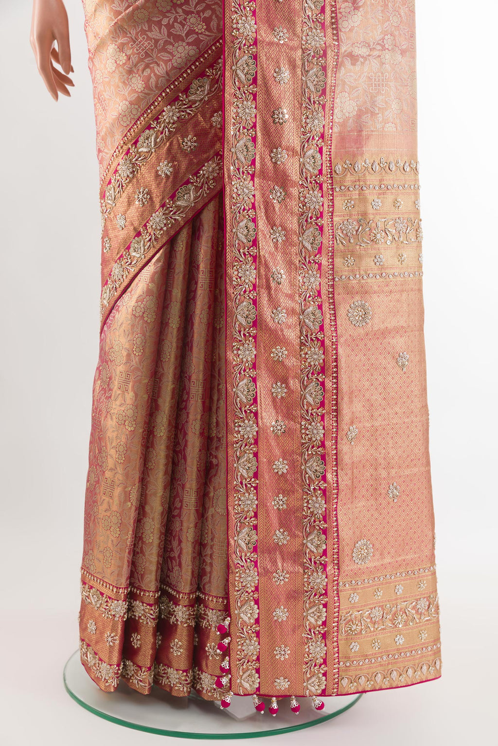 Pleats and pallu of Pink Kanjivaram Tissue Silk Saree with Zari Brocade on the body and Embroidery Border. 