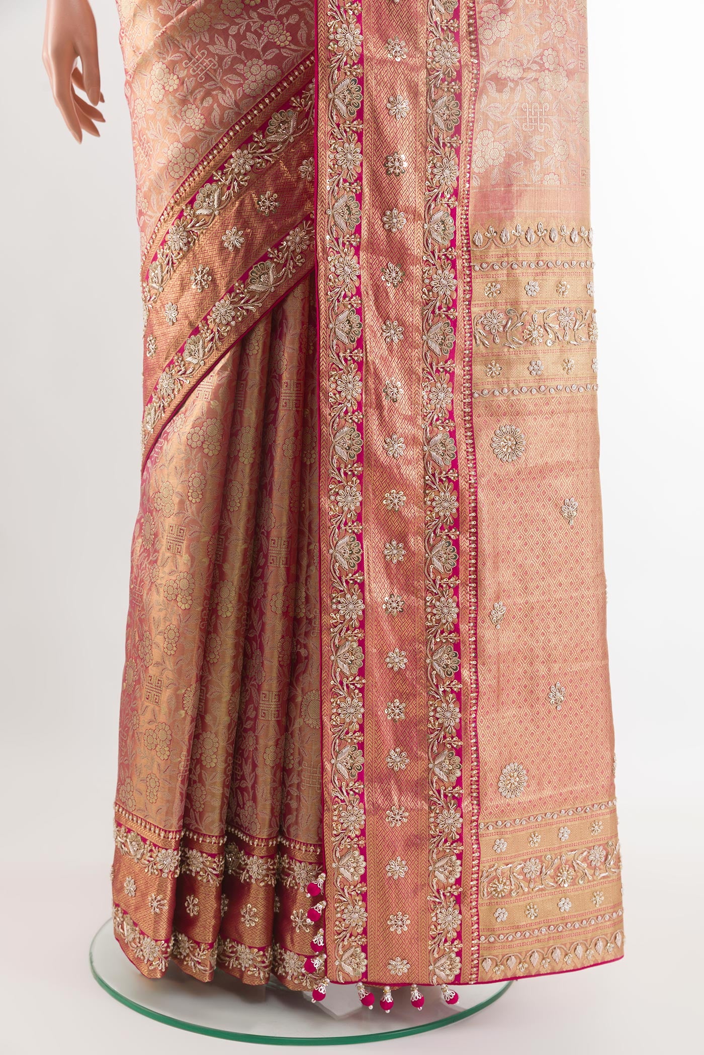 Pleats and pallu of Pink Kanjivaram Tissue Silk Saree with Zari Brocade on the body and Embroidery Border. 