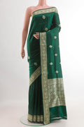 Green Banarasi Katan Silk Saree with Zari Butta on the body and Zari Border.  displayed on a mannequin